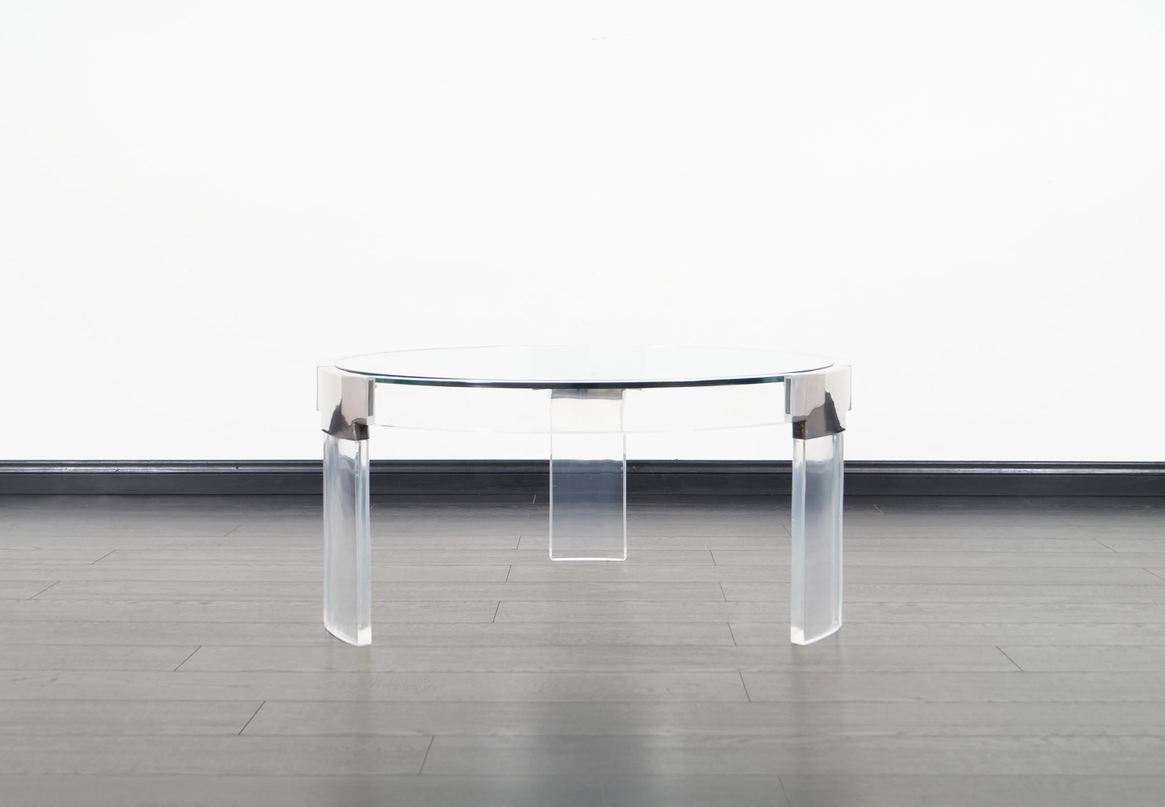 Fabulous vintage Lucite and chrome coffee table designed by Charles Hollis Jones in the United States, circa 1970s. This exceptional table is part of the “Waterfall Line” collection. Features a wide and elegant inset glass top with thick curved