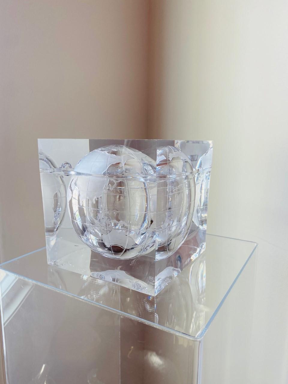 Beautiful lucite ice bucket cube depicting the world captured in a sculpture that resembles an ice cube. The effect displays a frosted world map of continents and orbiting moon. This piece was designed and created by Alessandro Albrizzi, Italy