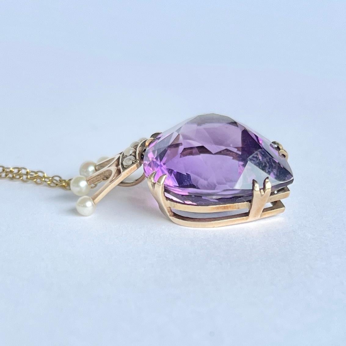 This gorgeous necklace holds a bright purple amethyst stone and a crown holding pearls. A Luckenbooth is a traditional Scottish love token often given as a wedding gift. The heart represents love and the crown is for loyalty. Modelled in 9 carat