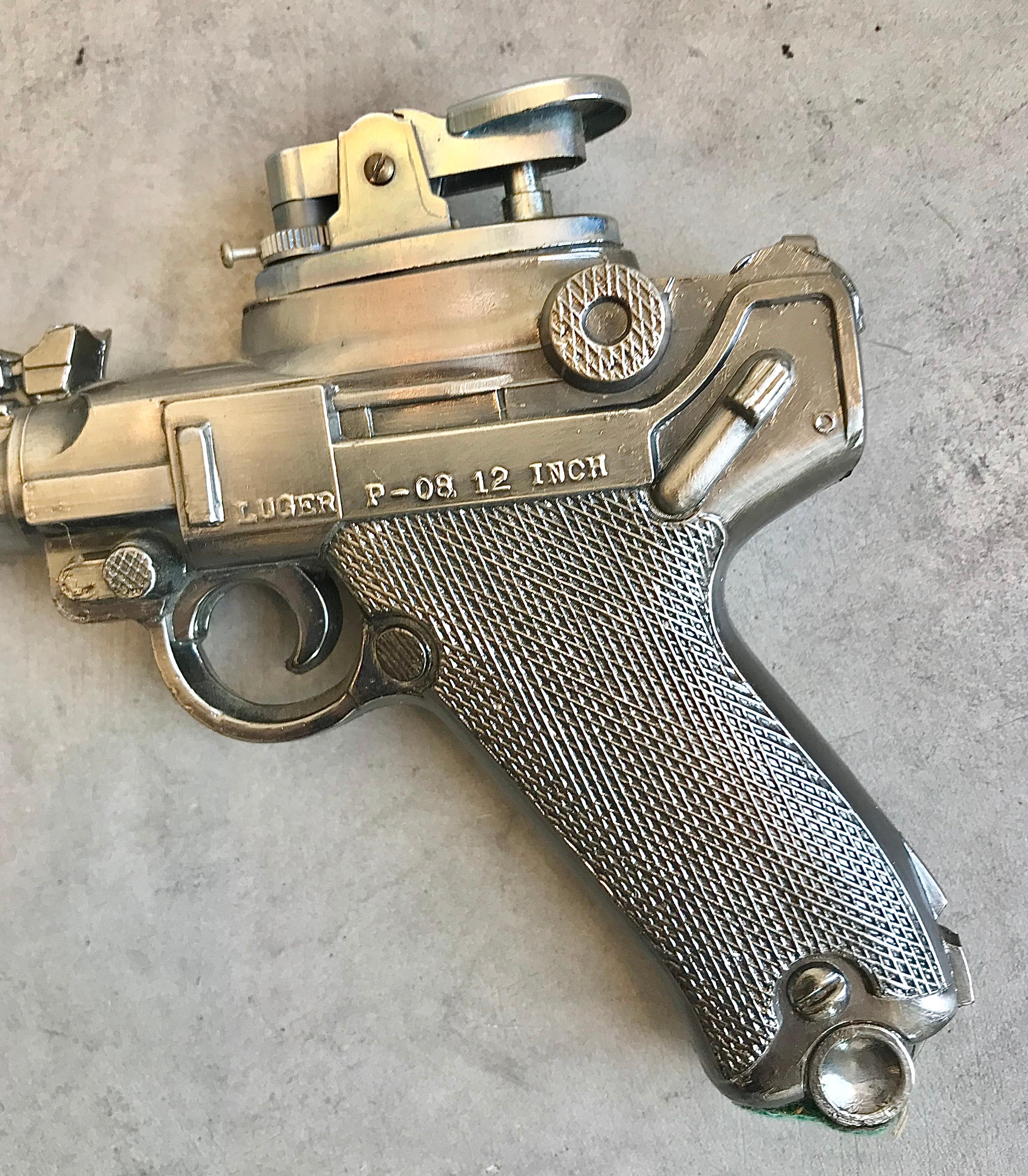 Cool vintage table lighter in the shape of a Luger P-08 12 inch handgun. Made of metal, cool tobacco accessory and conversation piece.

  