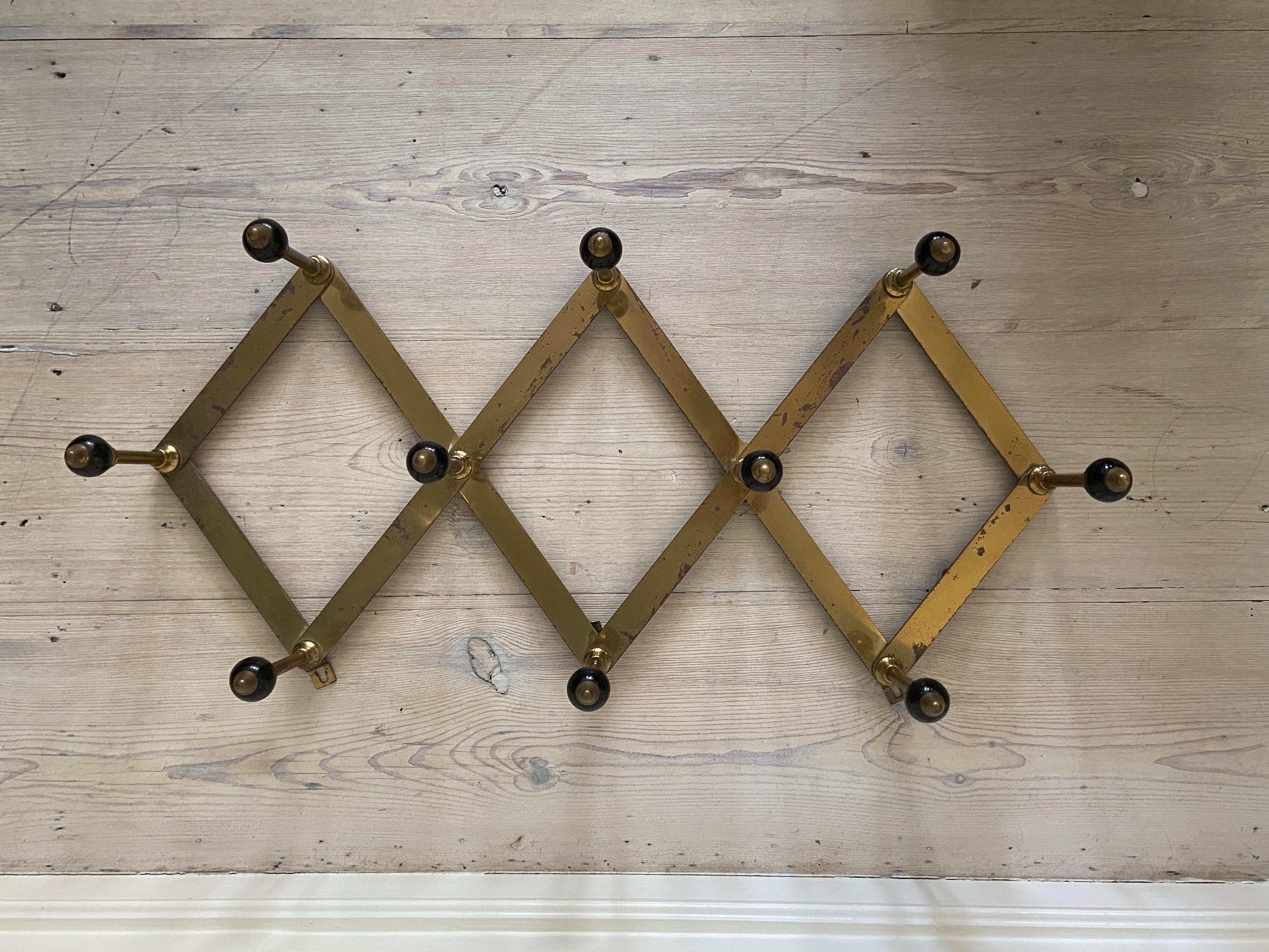 Luigi Caccia Dominioni
Italy, 1960s

Vintage Brass and Wood Coat Hanger with Elegant Patina. Produced by Azucena.

H 30 x W 73 x D 15 cm.