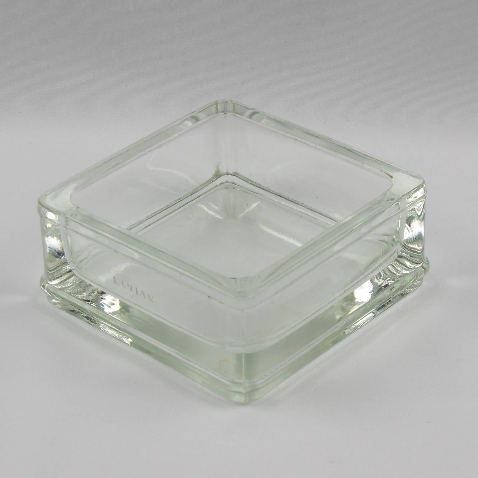 Industrial thick molded glass desktop accessory (desk tidy, ashtray or catchall) manufactured by Lumax, France. Original design by Le Corbusier. Engraved company logo on side. 
Measurements: 4.50 in. wide (11.5 cm) x 4.50 in. deep (11.5 cm) x 2.19