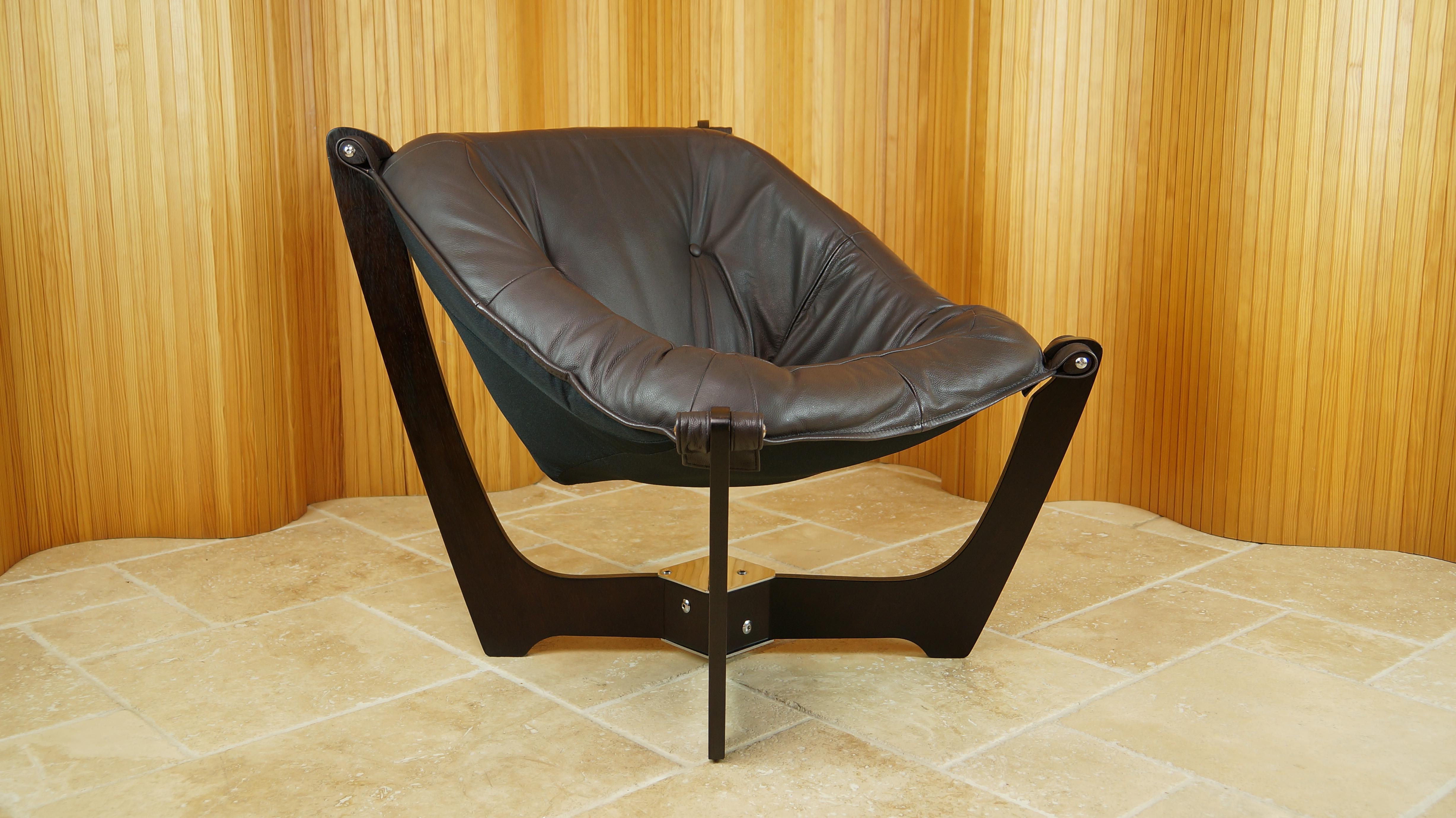 A wonderful 'Luna' armchair by Odd Knutsen for Hjellegjerde, Norway.

Frame of dark stained wood, mounted with dark brown leather seat designed in the 1970s.

Exceptionally comfortable, in absolutely excellent condition throughout and has just