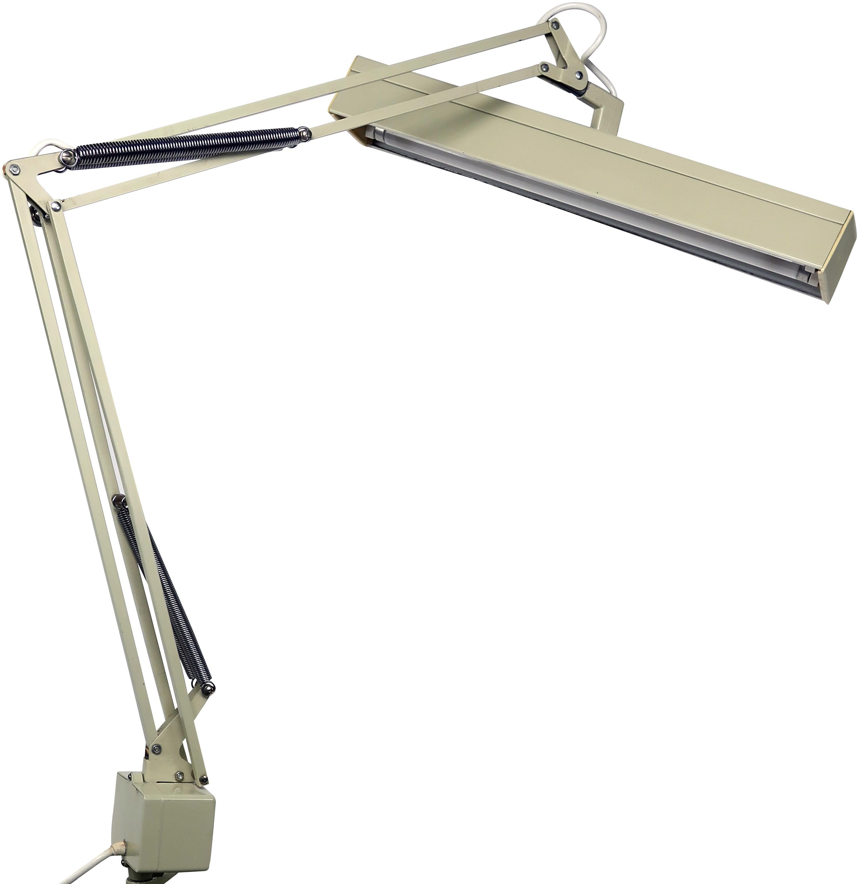 A vintage cream colored Luxo fluorescent desk lamp that screams mid-Century Modern. In excellent vintage condition with wear consistent with age and use. 

Measures: 19” x 16” x 34”
Extends to 19” x 16” x 44”.