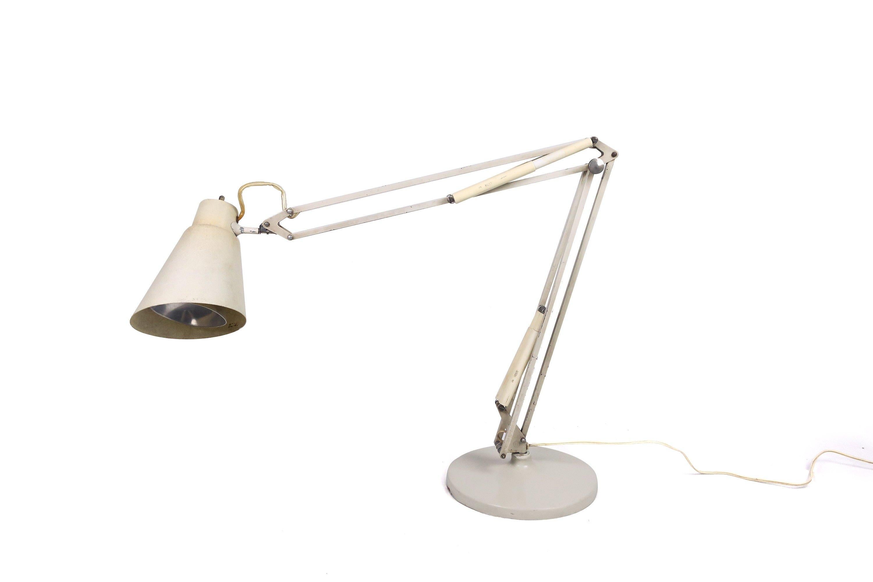 An early Luxo drafting lamp with white fiberglass shade, heavy white base, and white plastic “LUXO” embossed spring covers. Attributed to Jac Jacobsen. In vintage condition wth wear from use. Works perfectly!
 
Measures: 27” x 9.5” x 23” (extends