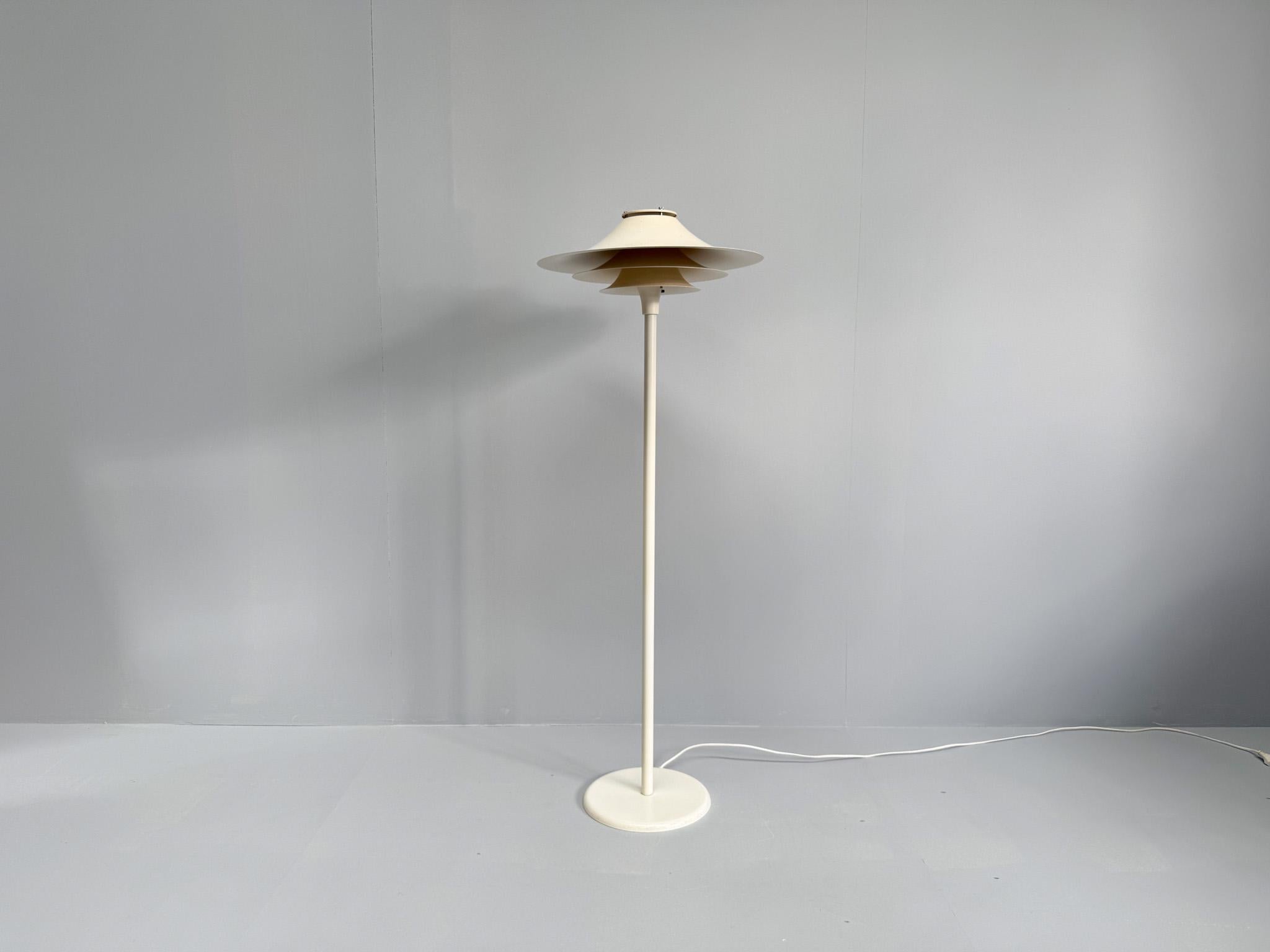 Bring home a rare piece of Scandinavian lighting history with this vintage floor lamp by Lyfa, model Adina, dating from the 1970s. This elegant Danish design features Lyfa’s signature layered shade structure that beautifully diffuses light, offering