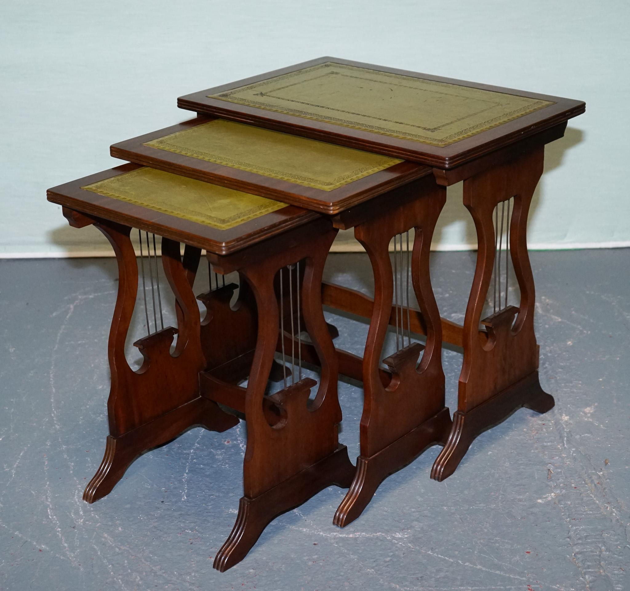 
Antiques of London



A stylish nest of three tables featuring elegant lyre-shaped supports and rich green tooled leather insets. This vintage set, likely mid-20th century, reflects refined craftsmanship and versatility, ideal for both traditional