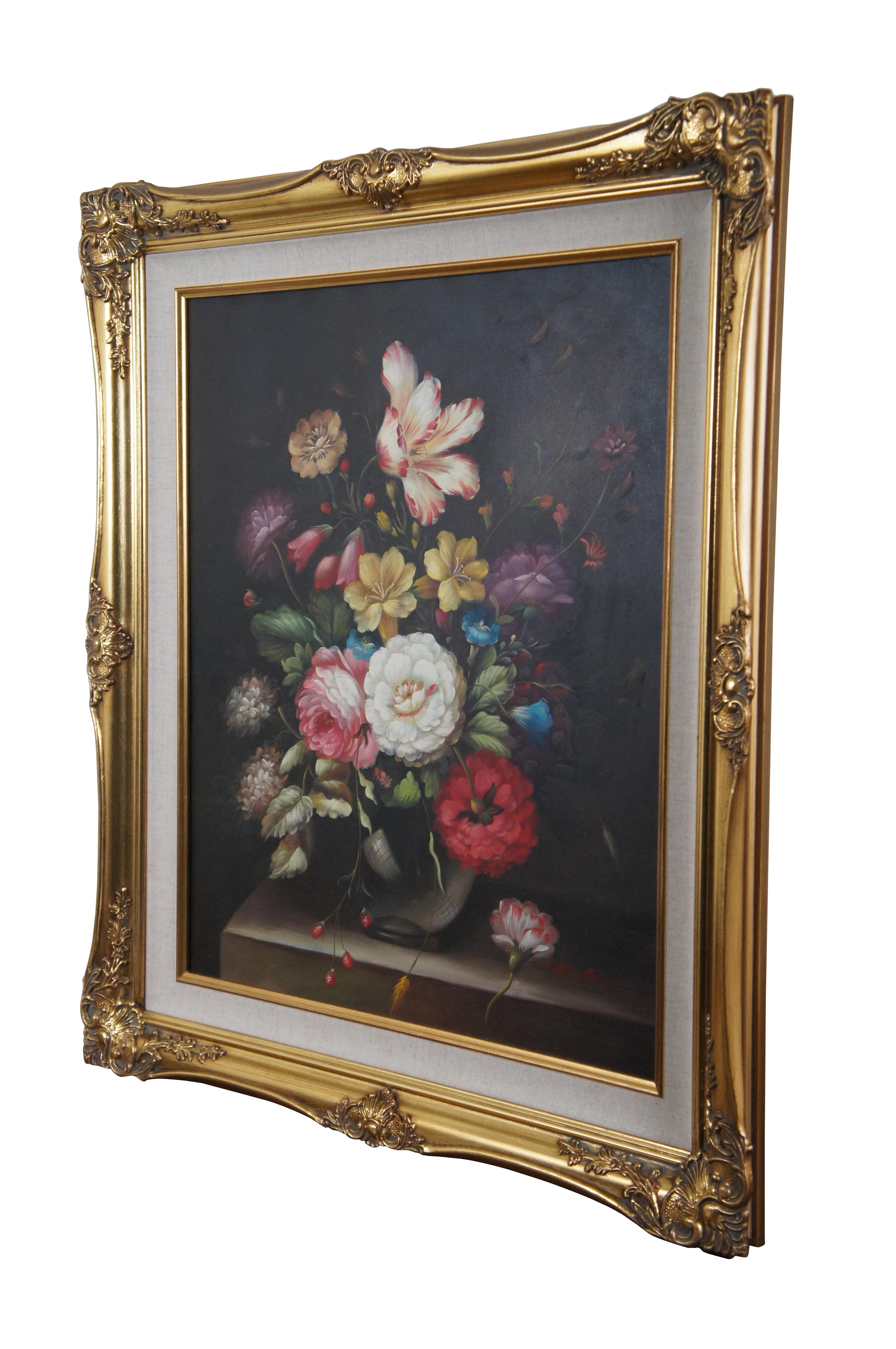 Vintage floral still life oil painting on canvas featuring a colorful bouquet of flowers in a vase on a table.  Signed lower right M Aaron.  Framed in ornate gold frame.

DIMENSIONS

27