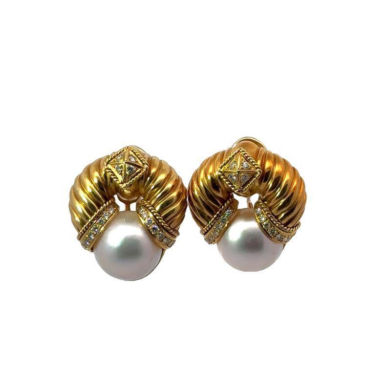 These vintage fluted gold earrings feature lustrous mabe pearls accented by 0.60 carat of sparkling diamonds, all set in 18k gold. Measuring 1-1/4 x 1-1/8 inches and weighing 36.24 grams, these bold earrings make a timeless statement with their