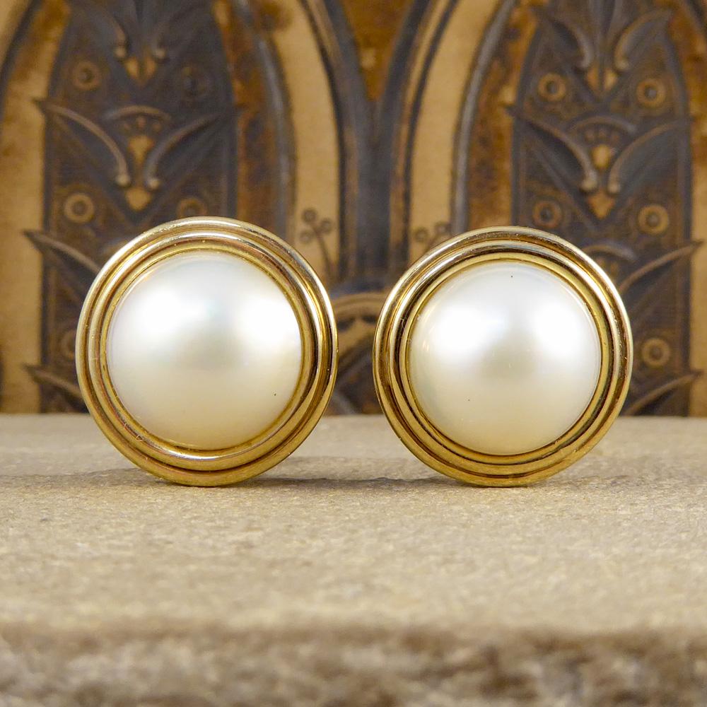 These lovely Mabe Pearl stud earrings are lustrous, rich and creamy pearls that shimmer with exquisite iridescence. With its silky overtones, these make pearl earrings are set in 18ct Yellow Gold with a 9ct Yellow Gold stem. Such a beautiful set of