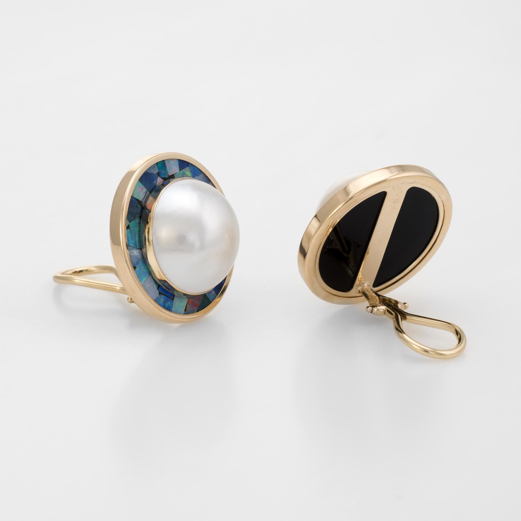 Elegant pair of vintage mabe pearl & inlaid opal earrings (circa 1960s to 1970s), crafted in 14k yellow gold. 

Mabe pearls each measure 16mm. The pearls are well matching and lustrous. Opal doublet chips are inlaid in a mosaic pattern around the