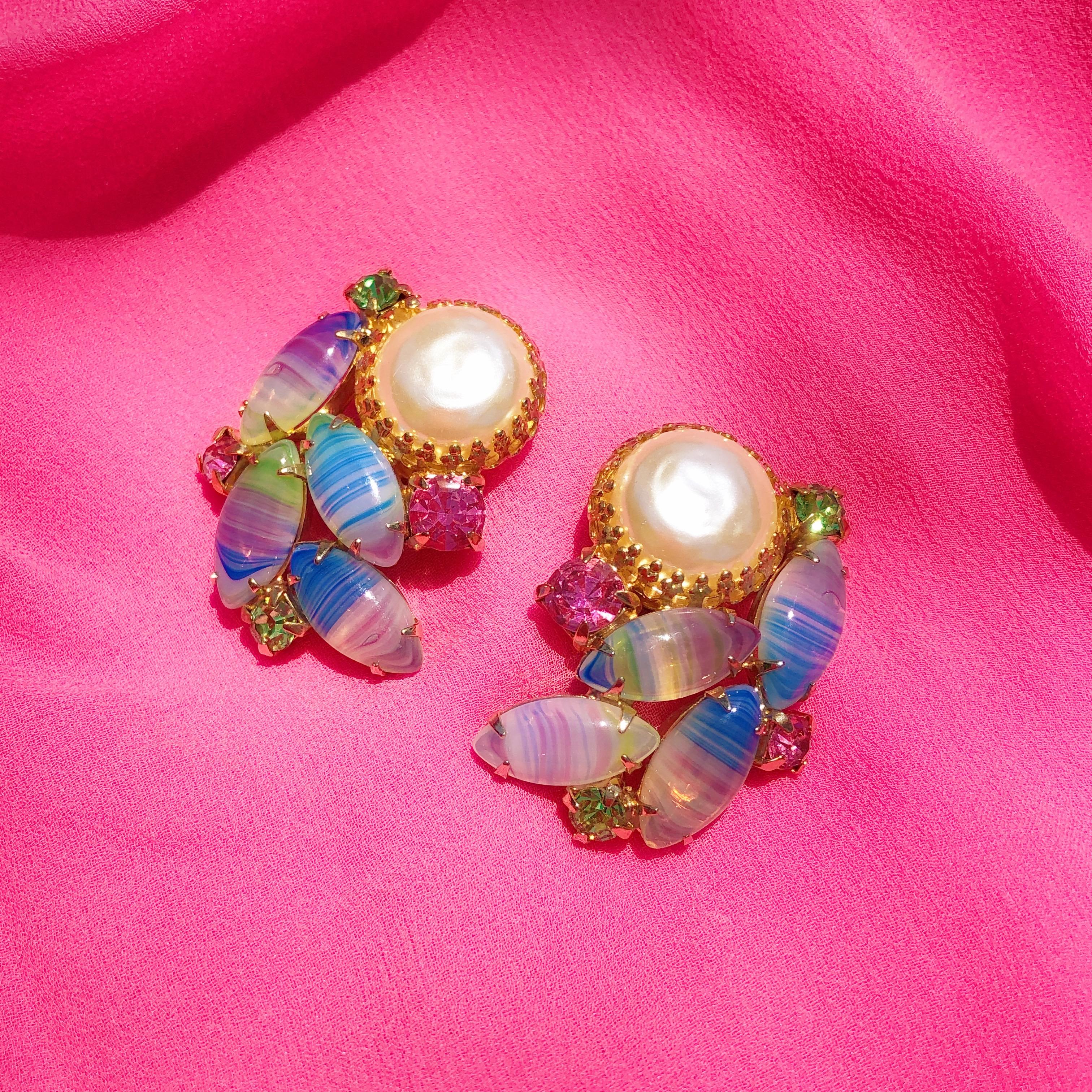 These stunning vintage Juliana-style statement earrings from the mid-century era make a truly unique statement! A cluster of multi-colored pastel Givre art glass stones, accented with pink and green rhinestones and a large faux Mabe pearl are prong