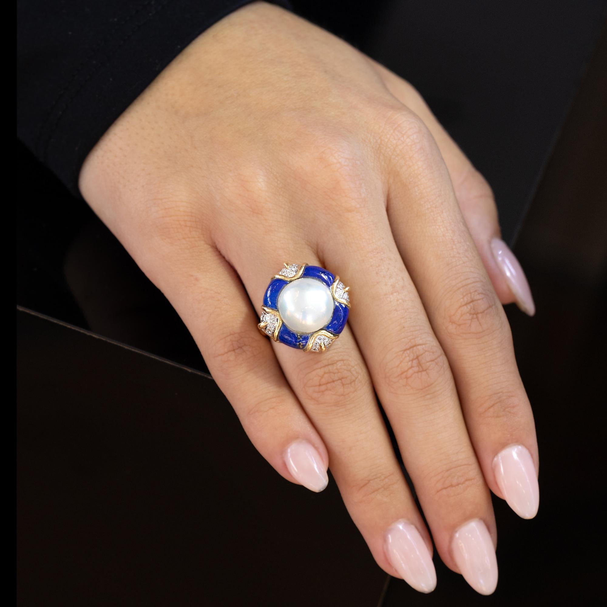 An icon of 1980's style, this mabé pearl classic cocktail ring remains a timeless classic. A bold, creamy and lustrous large pearl bordered by velvety blue lapis lazuli and glittering diamonds in a quatrefoil design makes a bold statement. Don't say
