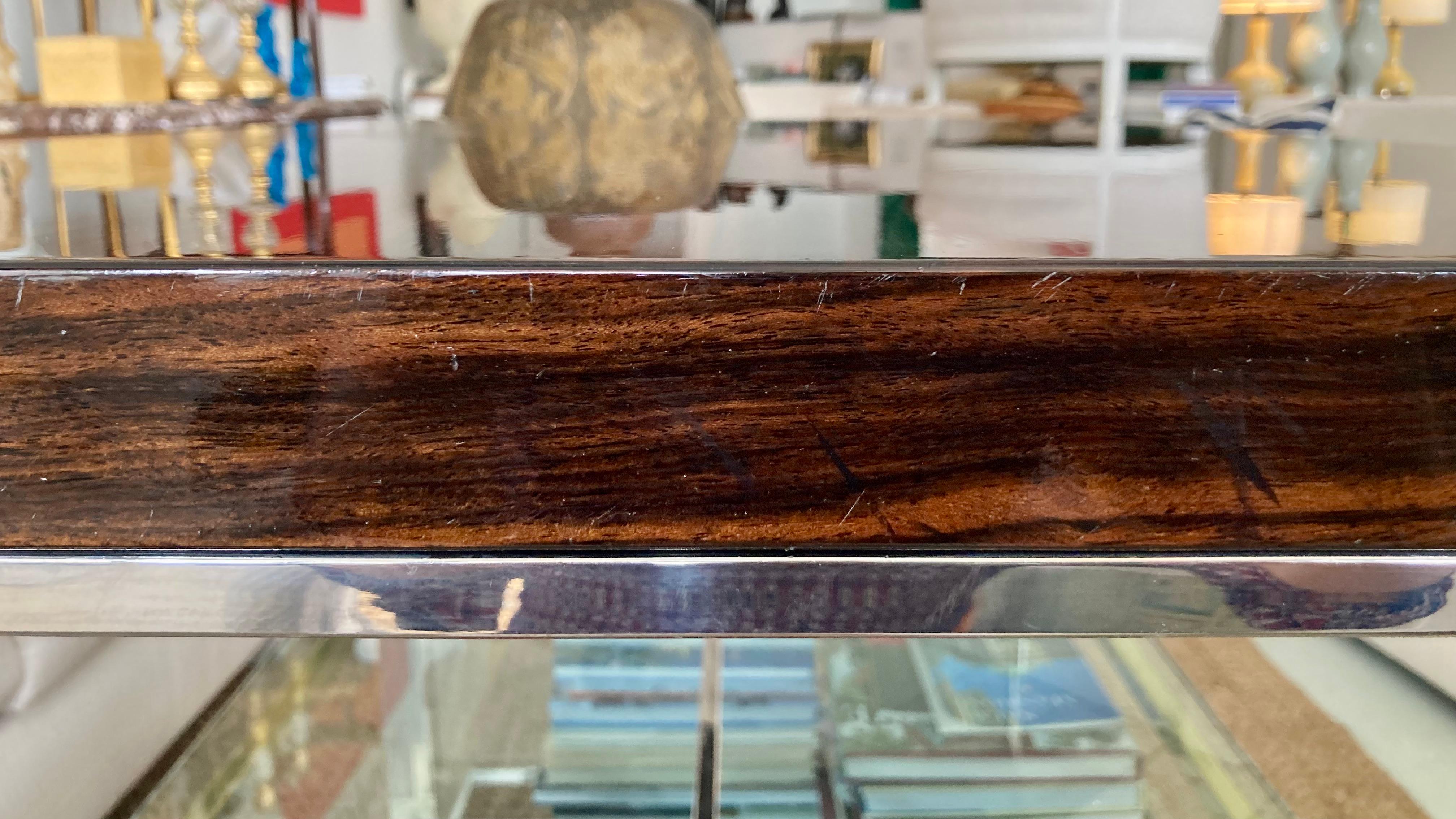 Vintage Macassar ebony coffee table with chrome base. Add some modern style to your home. Gorgeous high gloss finish very reflective. Nice original wear to surfaces. There are some surface scratches and an older repair however overall it is
