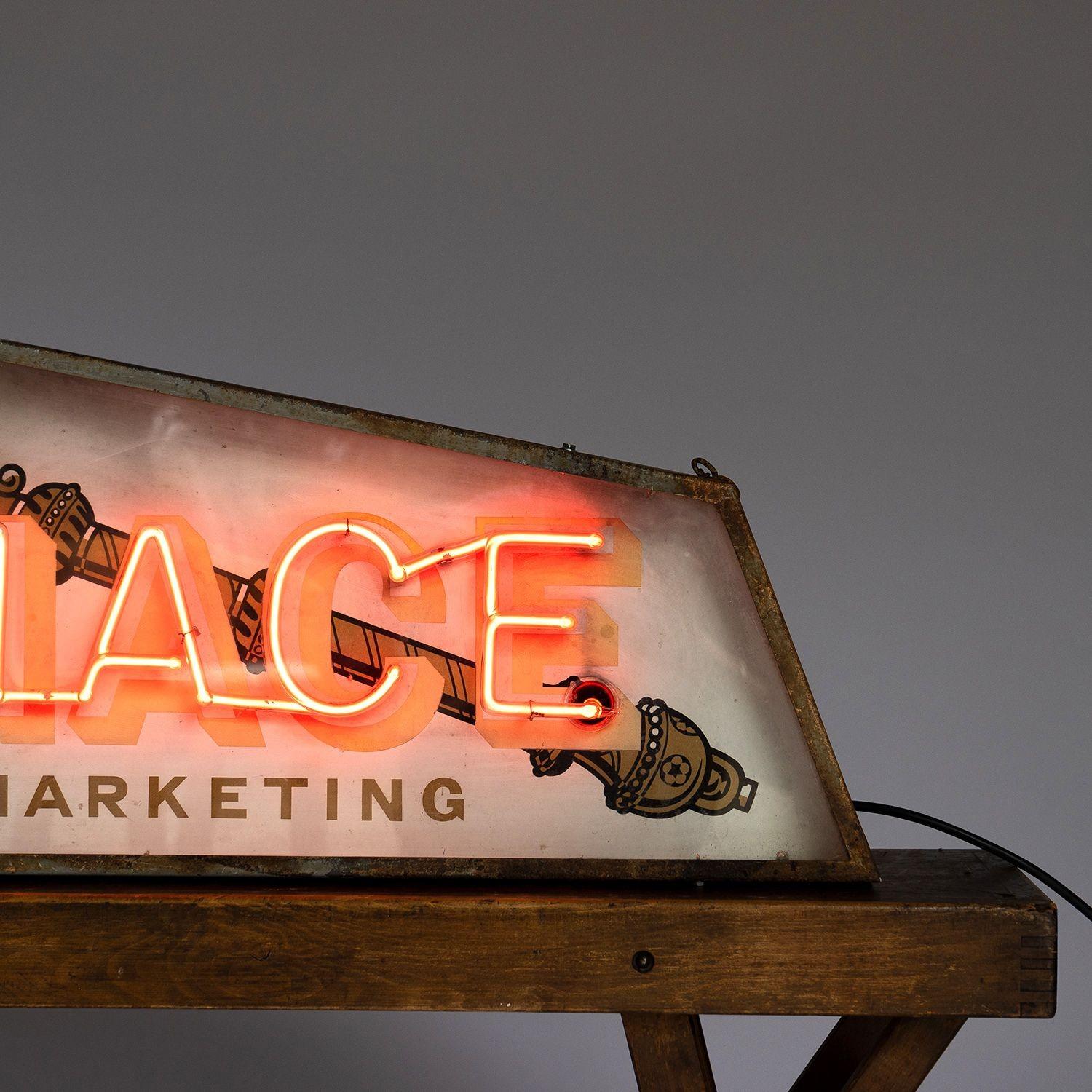 Mid Century Illuminated Advertising Sign 
 
Illuminated red letters spelling out 'MACE' over a pictorial background illustrating a mace. 
 
Angled steel and glass case.
 
Can either sit on a shelf/table or can be hung from the ceiling.
