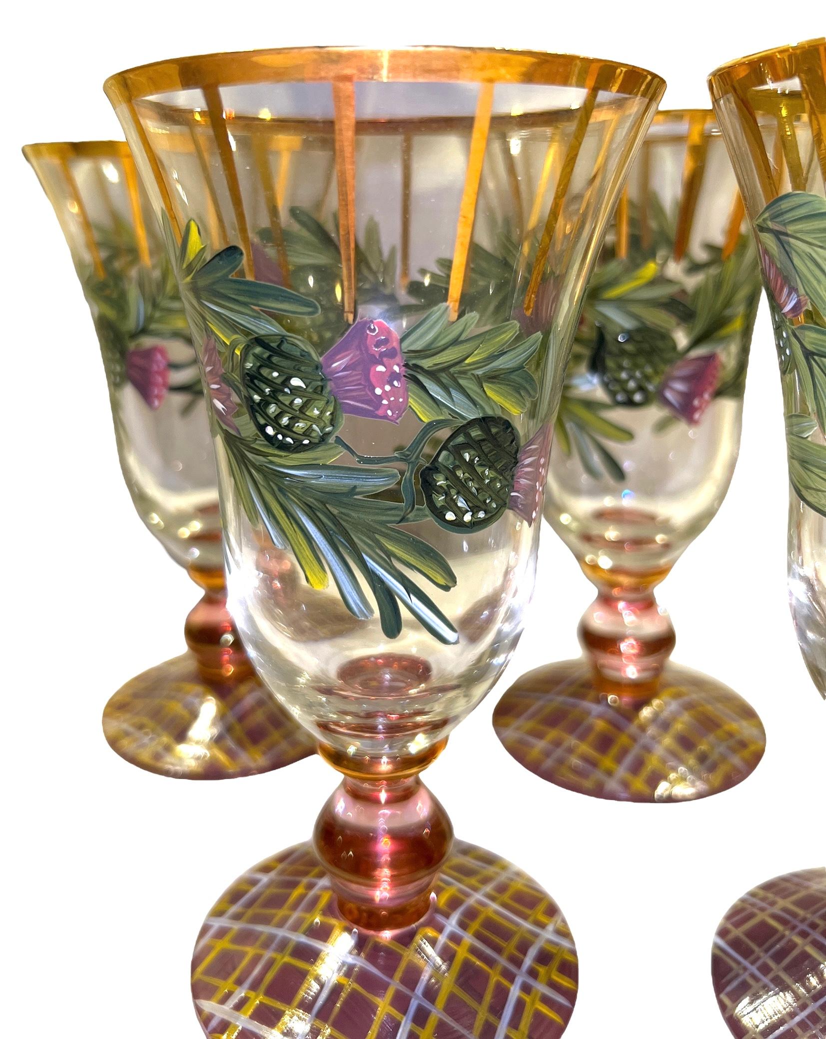 Excellent condition! These rare whimsical glasses will be a statement piece to any table decor! Decorated in gold around rims, down sides as well as sprinkled on bottom; painted in forest green, burgundy, and gold; greenery along with purple