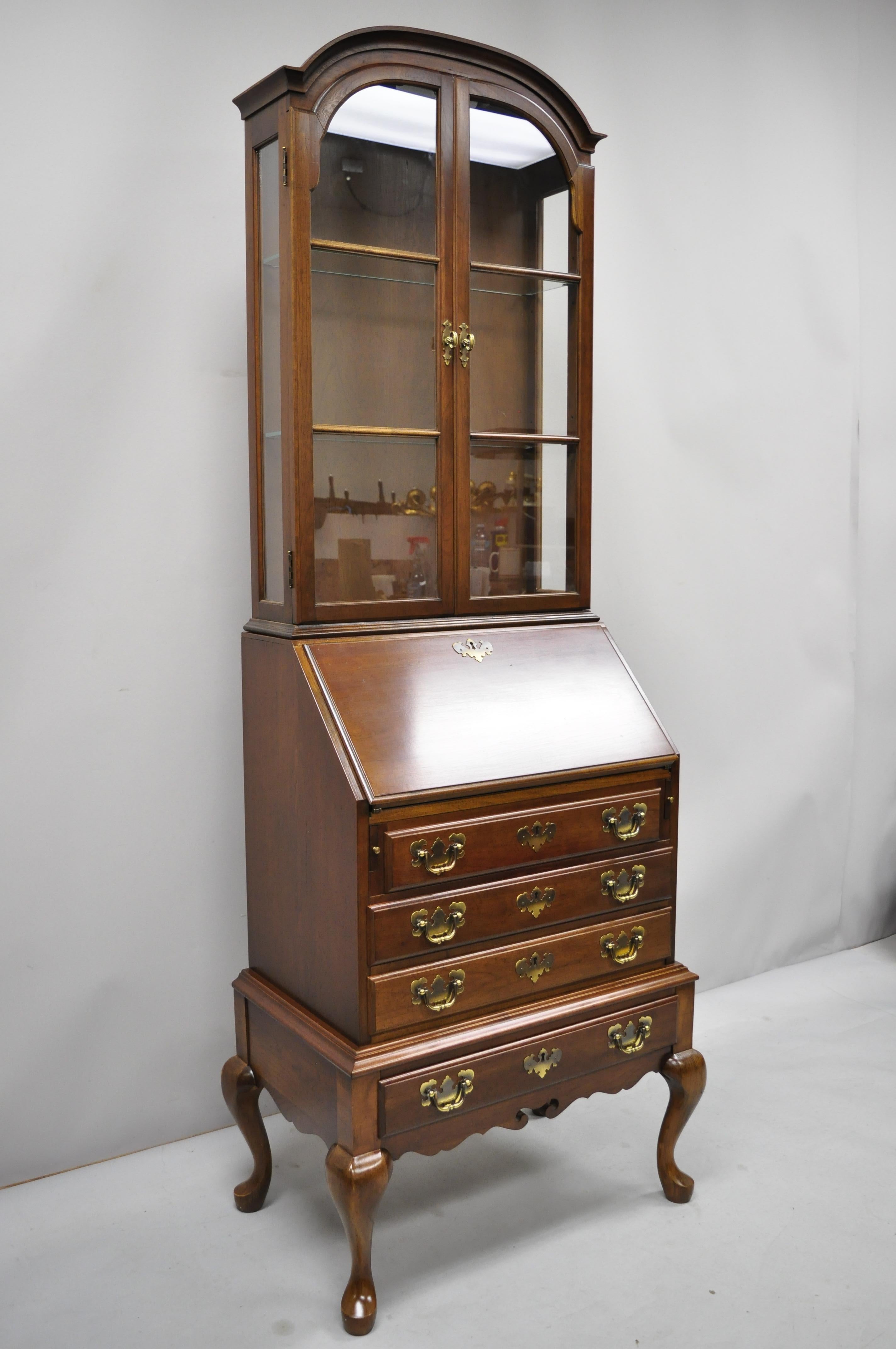 Vintage Maddox Queen Anne cherry small secretary desk display curio bookcase. Item features solid wood construction, nice smaller size, beautiful wood grain, 2 part construction, lighted interior, 2 glass swing doors, original labels, working lock