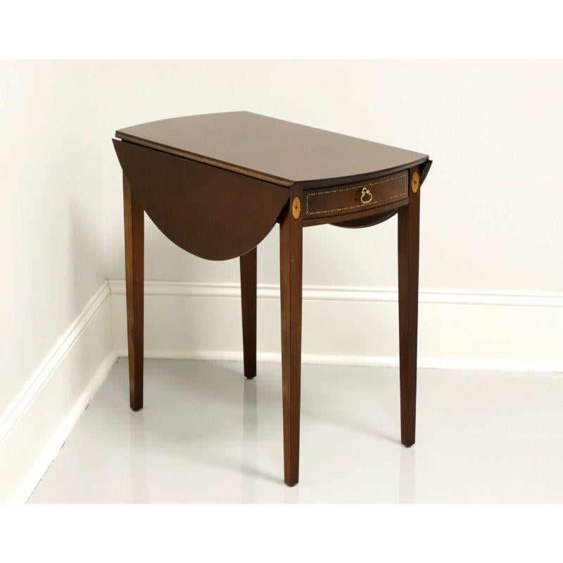 A Hepplewhite style pembroke table by Madison Square, of Hanover, Pennsylvania, USA. Mahogany with inlaid details and brass hardware. Features one drawer of dovetail construction. Made in the mid 20th century.

Measures: 14.5 W 26.25 D 24.75 H,