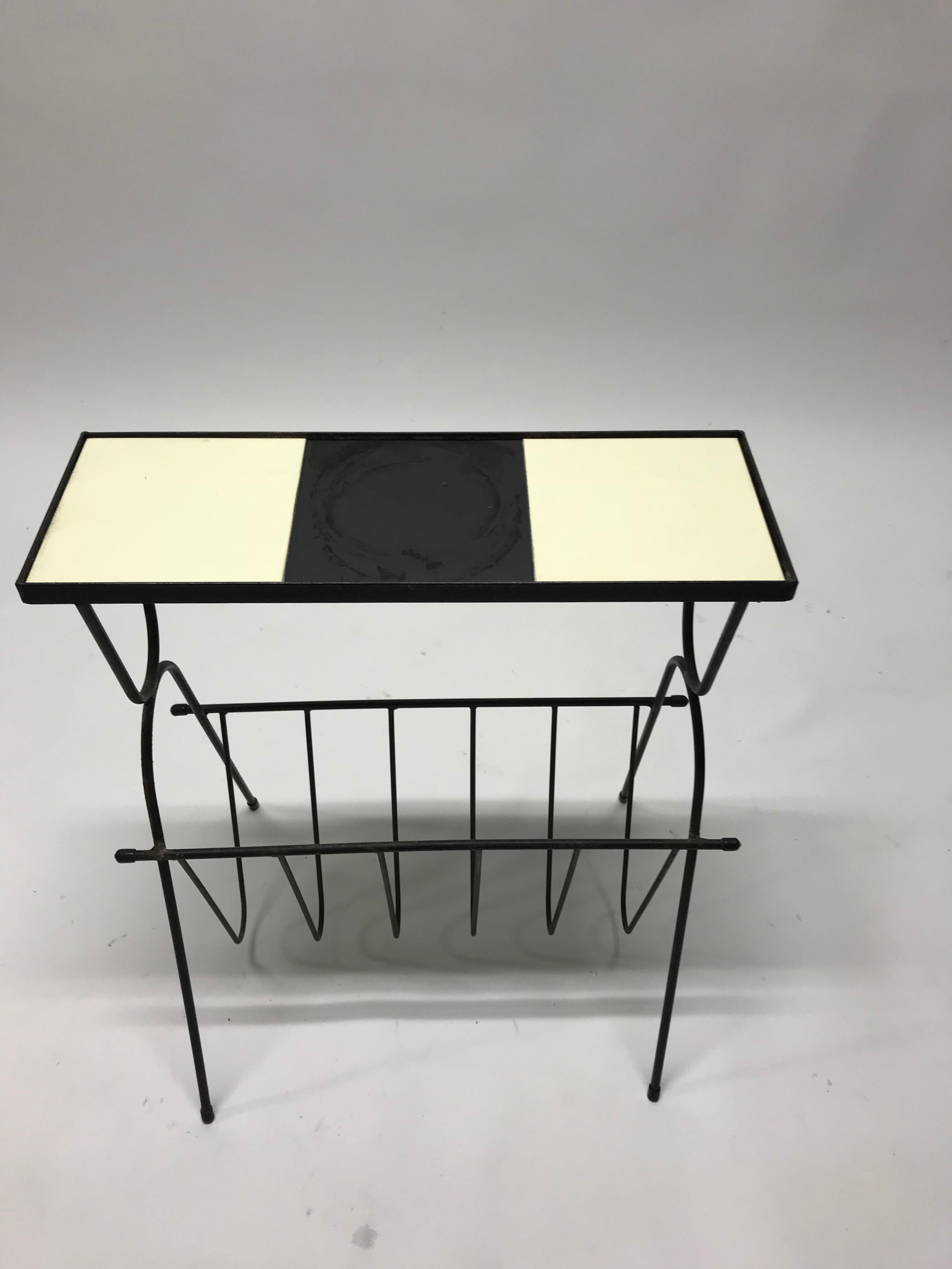 Vintage black metal magazine rack with black and white ceramic tiles top. 

Slight wear on the metal

1970s, The Netherlands.

Dimensions:
Height 55 cm/ 21.6