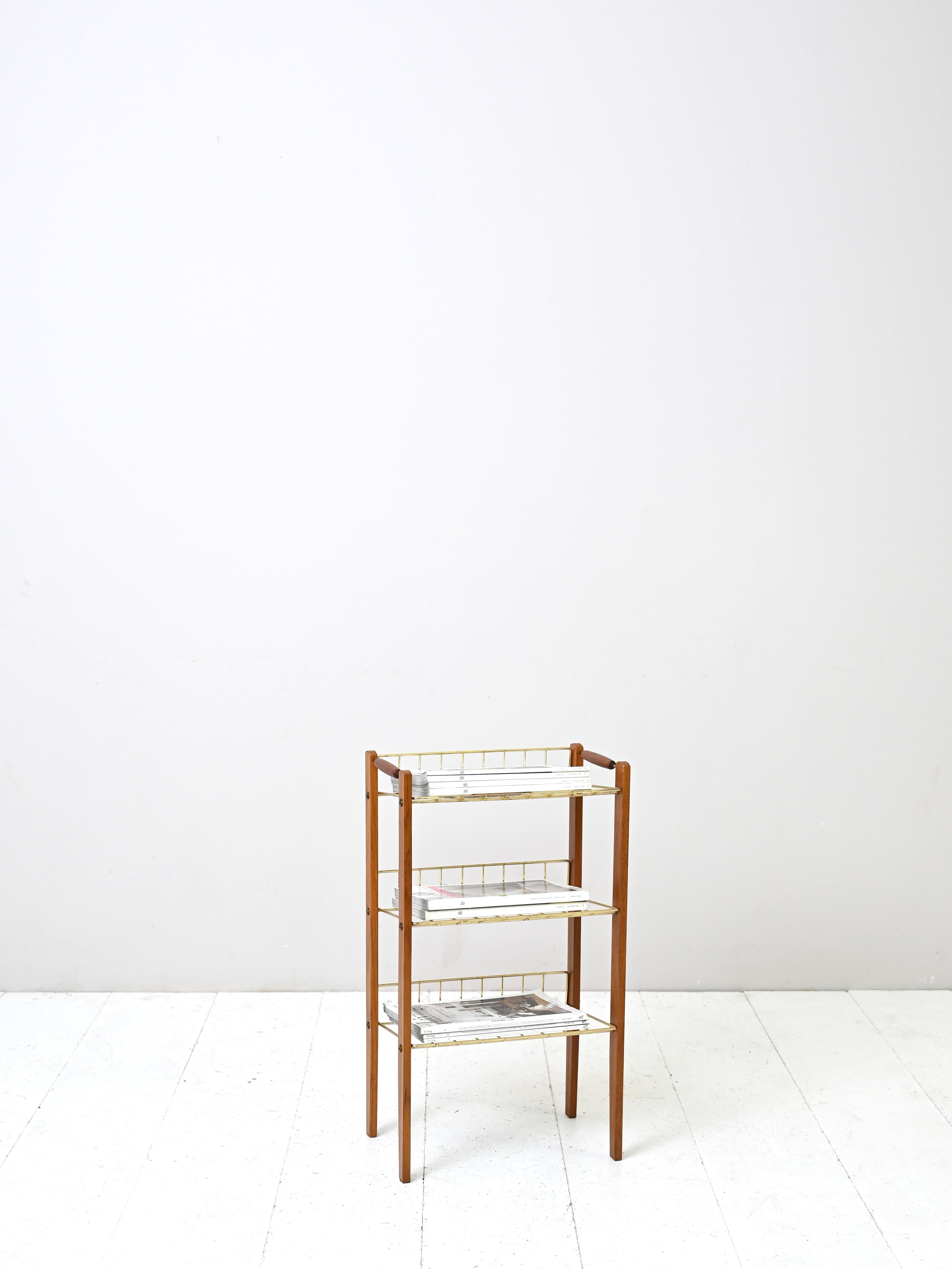 Scandinavian magazine rack with three shelves.
The frame is made of metal and teak wood.

Scandinavian original vintage manufacture from the 1950s.

Good condition. A conservative restoration has been done. May show signs of time. Please pay