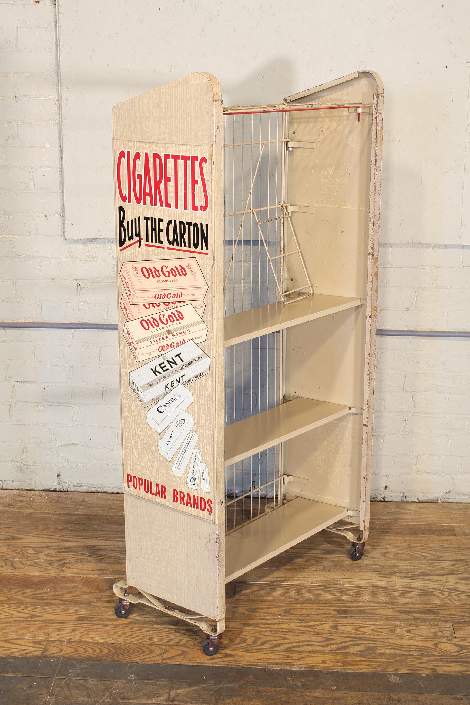 Vintage metal newspaper or magazine rolling rack, stand featuring cigarette / tobacco advertisement graphics. Overall dimensions - 27 3/4