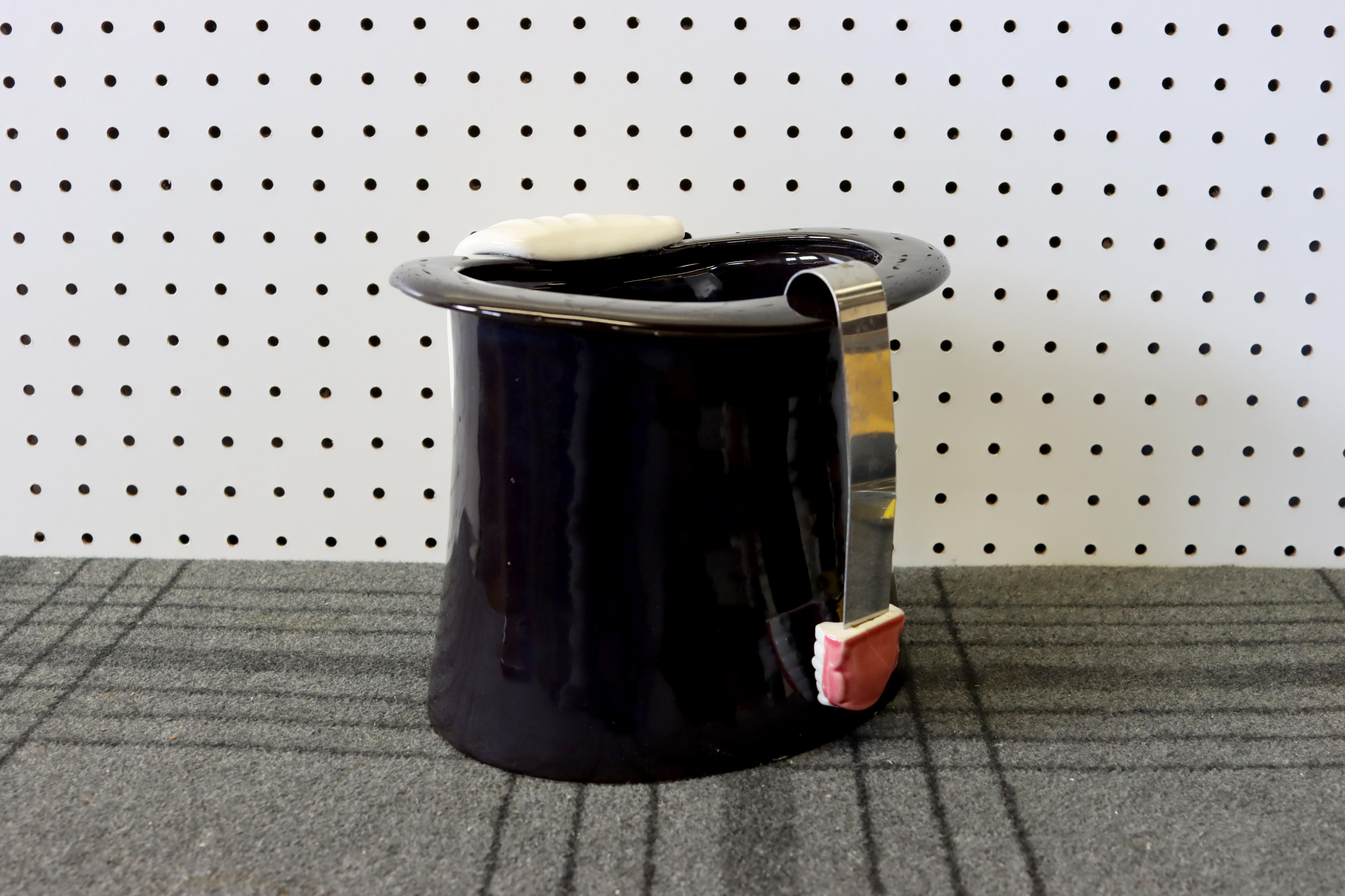 A playful and hilarious grouping of an ice bucket in the form of a magician's hat and tongs in the form of dentures. Sure to make an impression on your guests at the next party.

Ice bucket is in great condition, free of chips and damage. The