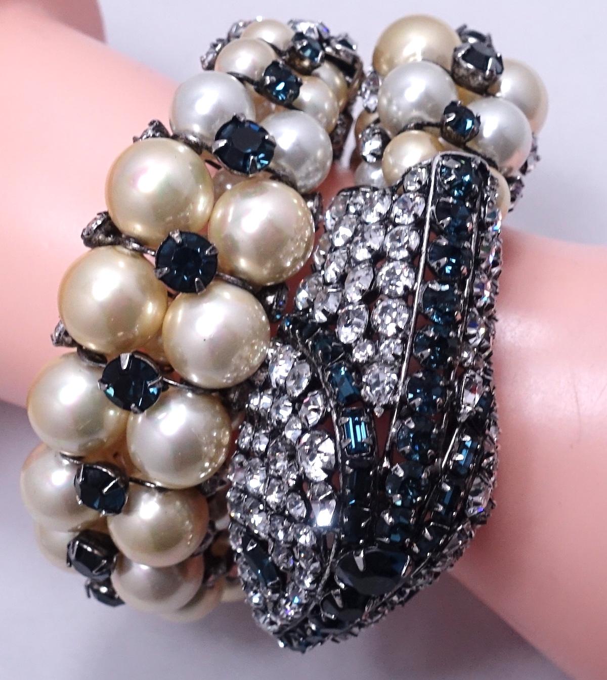 This is such an incredible vintage piece by Iradj Moini.  The bracelet features faux pearls with shimmering clear and black crystals in a gold tone setting.  The snakehead measures 2-1/2” long x 1-1/4” wide; the wrap bracelet measures approx. 13”