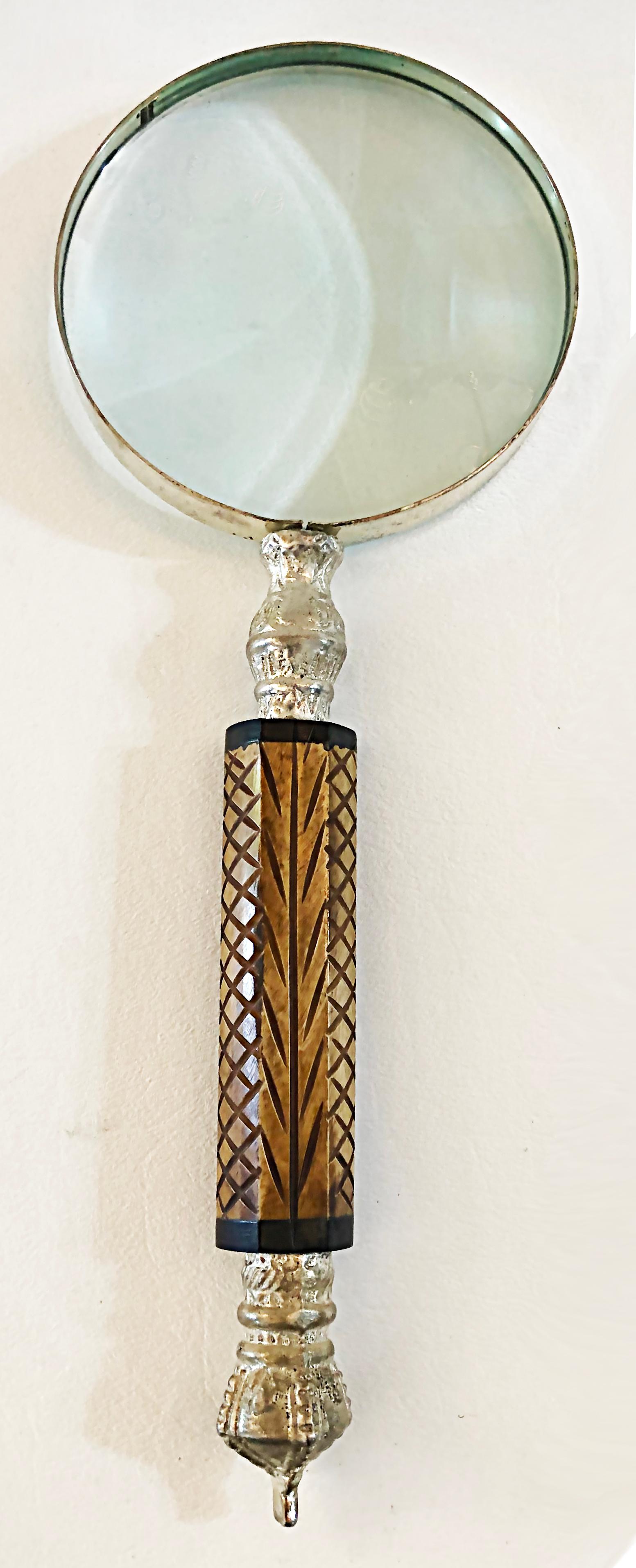 Vintage Magnifying glass with carved bone handle

Offered for sale is a vintage 20th-century magnify glass with a silver tone frame and a carved bone handle. The frame shows some vintage patina that adds to an antique look.