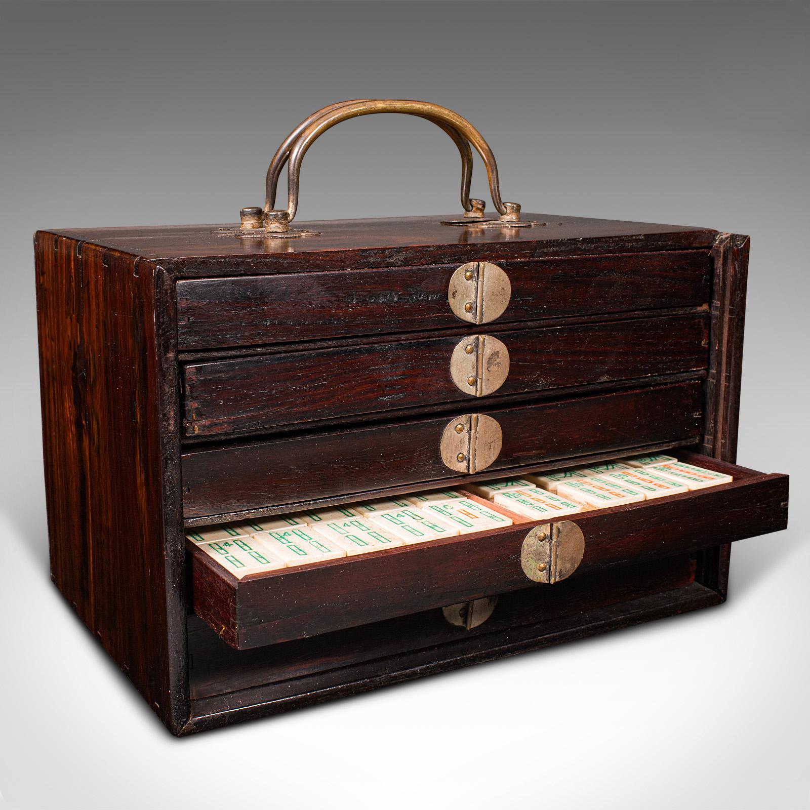 This is a vintage Mah-jong set. A Chinese, walnut cased gaming set, dating to the mid 20th century, circa 1960.

Appealing walnut and bamboo set with accessories
Displays a desirable aged patina throughout
Select stocks to the case with inlaid