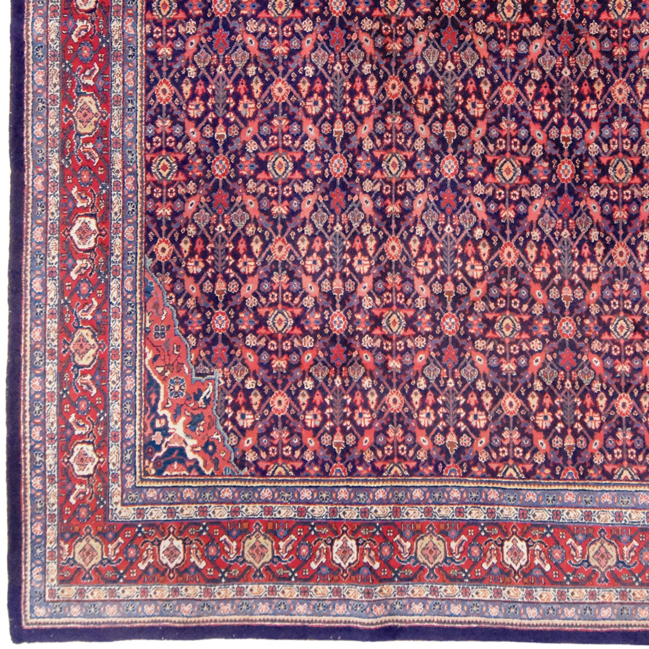 This magnificent early 20th-century Mahal carpet we offer is one of the finest examples of Iran's rich carpet-weaving tradition. Its striking colors and elegant geometric patterns reflect the masterful craftsmanship of its time.

Mahal carpets are