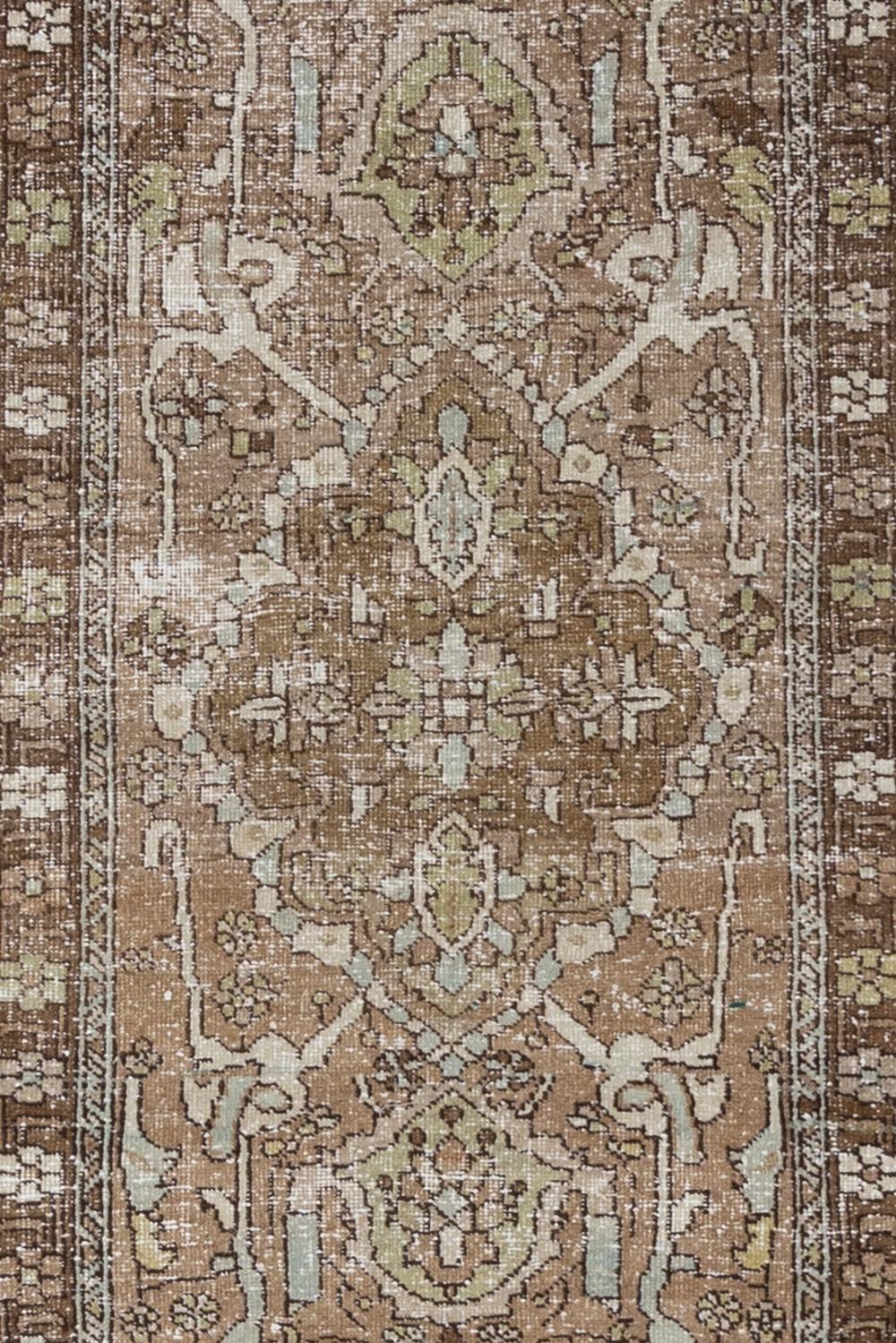 Age: 1940's

Colors: mocha, blue, chartreuse, tan, off white

Pile: low

Wear Notes: 4

Material: wool on cotton

Vintage Persian runner with a warm tan field and earthy accents. Safe for high traffic. 

Vintage rugs are made by hand