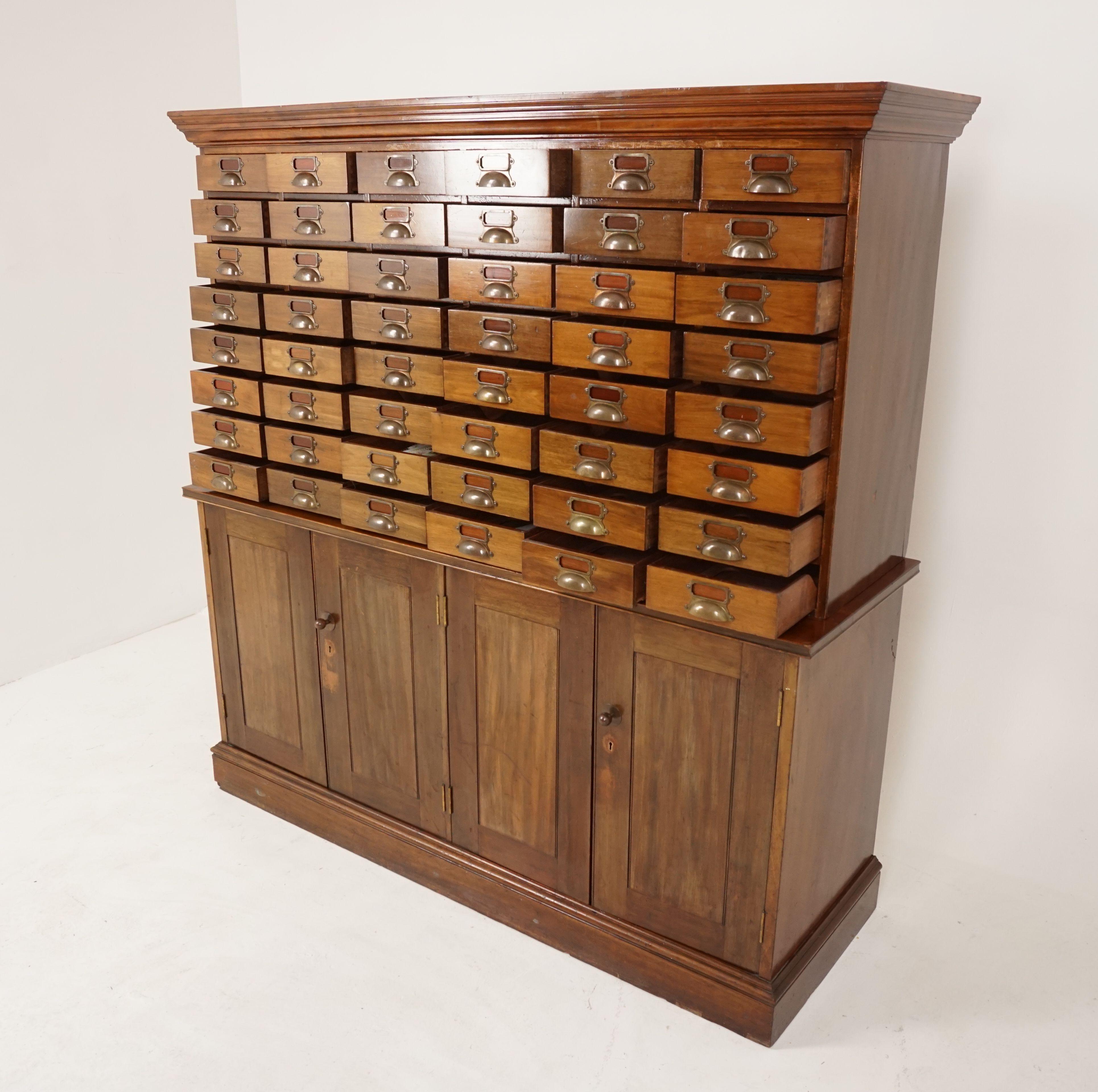 Vintage Walnut 48 drawer file cabinet, cupboard, Scotland 1920, H204

Scotland, 1920
Solid Walnut
Original finish
Moulded top with large flared out cornice
48 pull out dovetailed file drawers
With original brass pulls and index file card holders
The