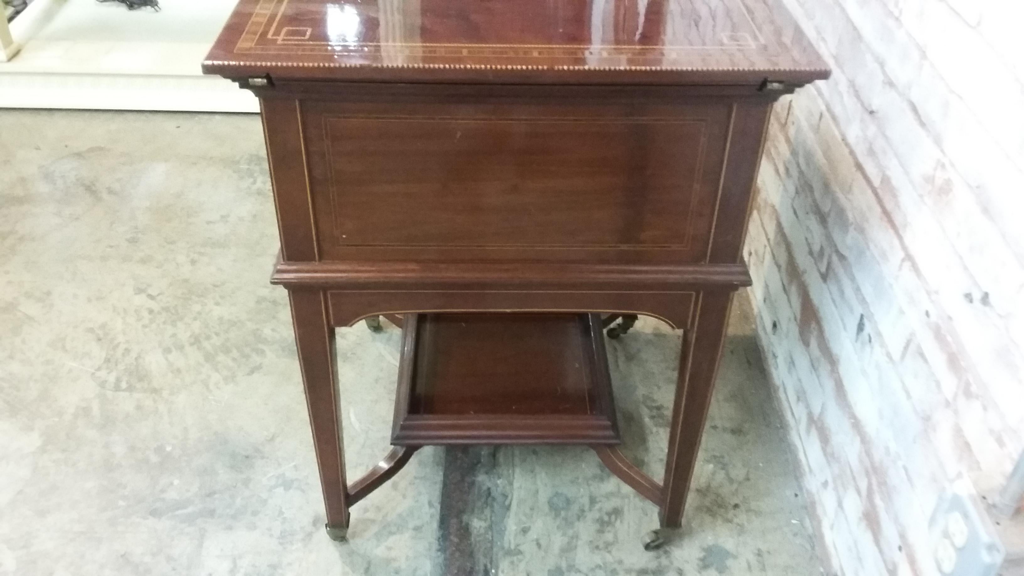 Vintage mahogany bar cart. Signed J. Bagshaw & Sons. Church Street Liverpool. Pats # 1631. # 5466. Opens to display 3 cut glass liquor decanters. Marked Scotch, Vodka, & Brandy. There is a removable serving tray as well as a storage area for cigars,