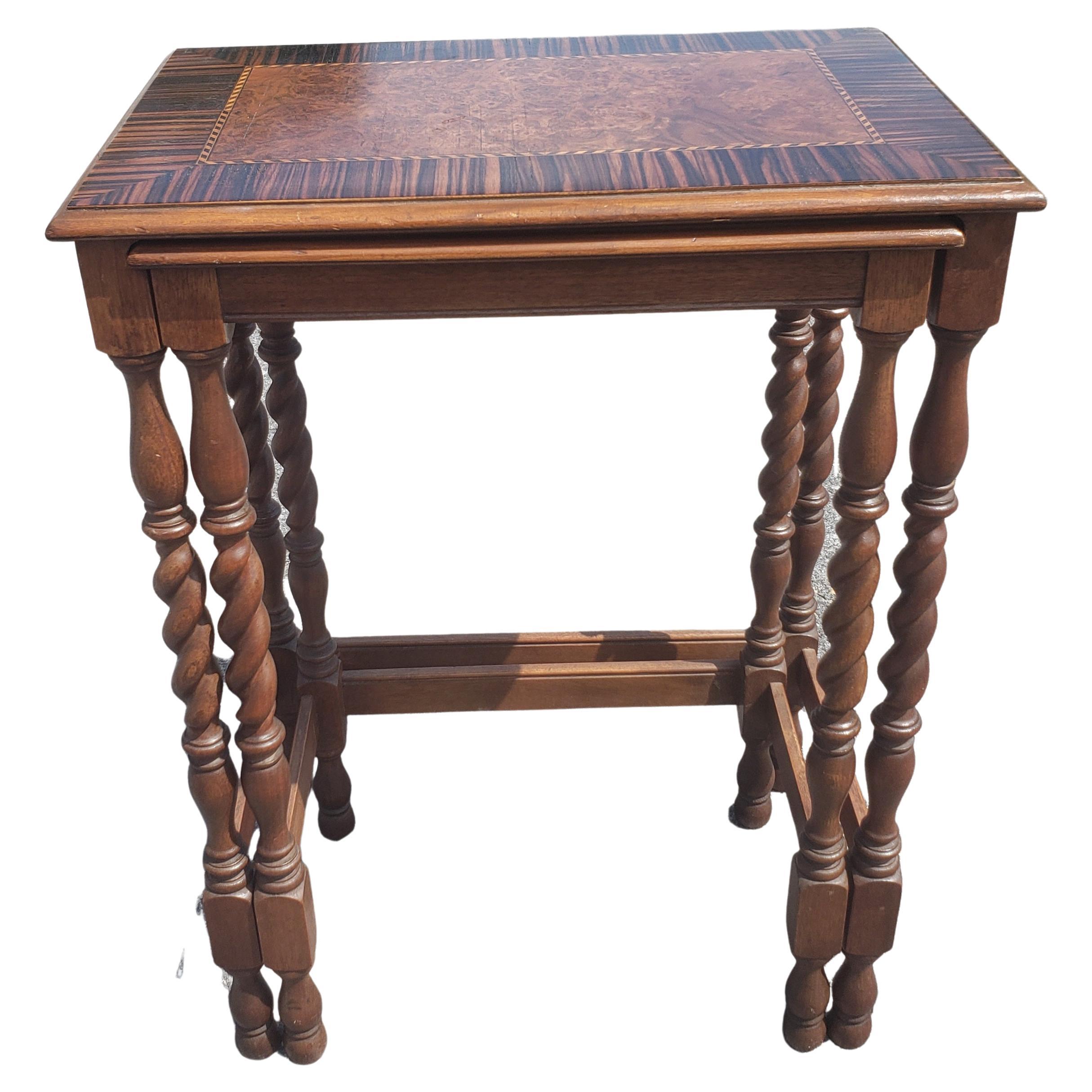 A beautiful pair of mahogany barley twist legs, inlaid banded and  burlwood top with a variety of fine woods such walnut, mahogany, kingwood, satinwood nesting tables in good vintage condition.
Larger table measures 18.25