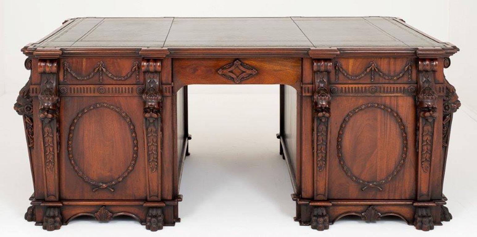 This magnificent flame mahogany lion's head partners desk demonstrates the highest standards of the cabinet maker’s craft and dates from the second half of the 20th Century.

This desk is an exact copy of the desk supplied by Thomas Chippendale to