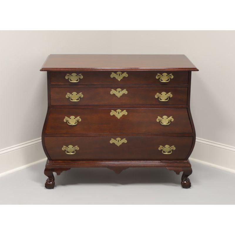 A Chippendale style bombe chest, unbranded, similar in quality to high-end furniture makers, such as Henredon. Solid mahogany with brass hardware, bombe shape, and ball-in-claw feet. Features four locking drawers. Includes one key. Made in the USA,