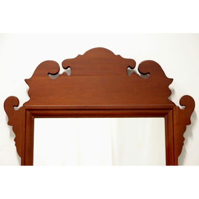 A Chippendale style, smaller size, wall mirror, unbranded. Mirror glass, mahogany frame with decorative carving to top and bottom. Made in the USA, in the late 20th Century.

Measures: 19W 1D 32H, Weighs Approximately: 6 lbs

Excellent condition