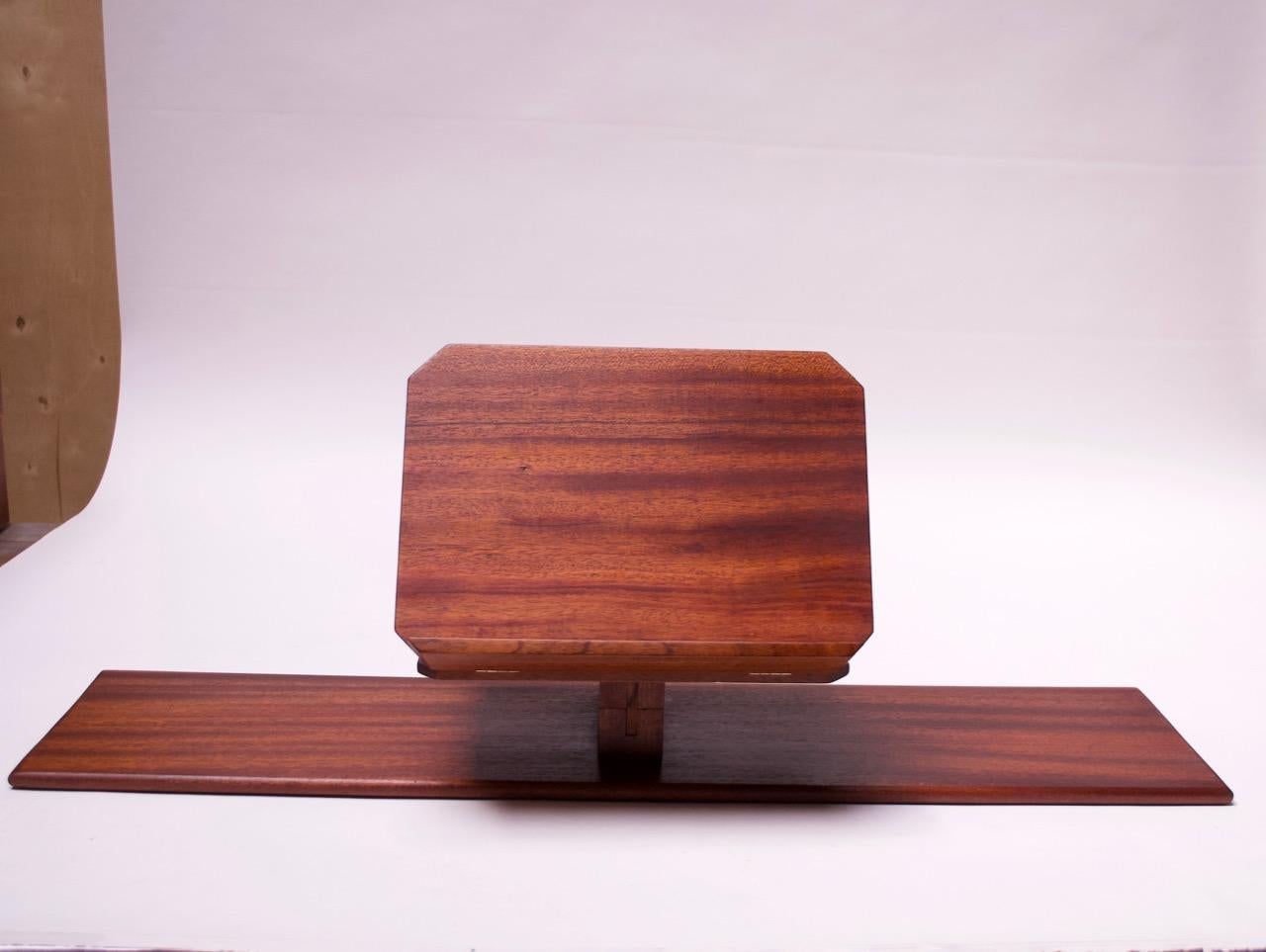Ingeniously designed lectern composed of two pieces: a base board with two pedestals and a stand, all in solid mahogany. The stand can attach to one of the two cruciform pedestals (depending on preferred height). The hinged stand is easily removable
