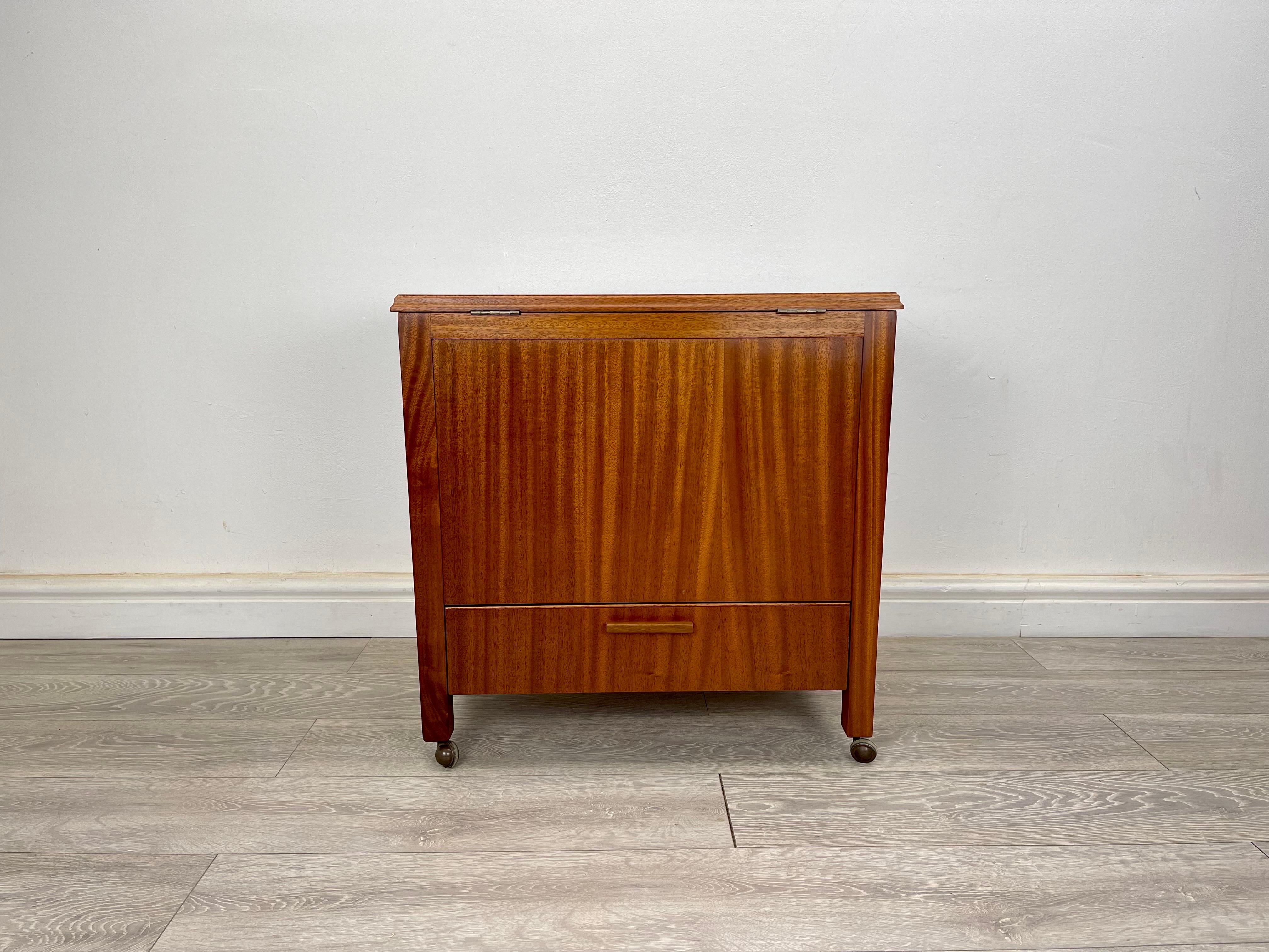 Drinks cabinet
A vintage mahogany drinks cabinet circa 1950s. The drinks cabinet stands on metal castors, there’s a drop down drawer giving you storage for bottle, the top of the cabinet opens up to reveal a pop up drinks cabinet giving you storage
