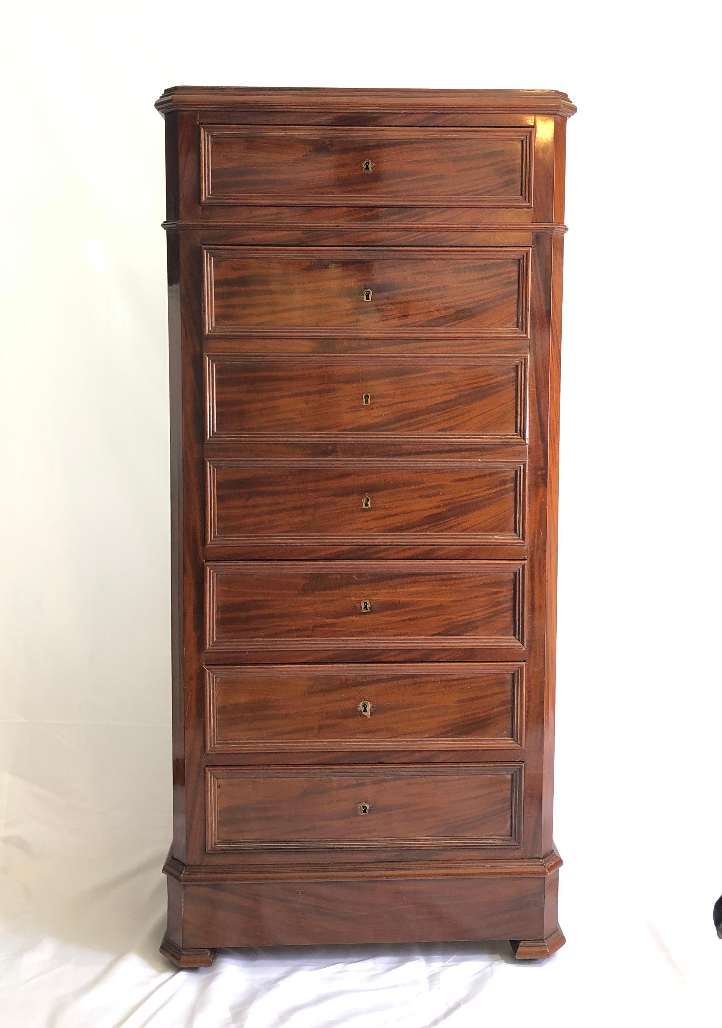Beautiful warm highboy dresser with drop-front secretary. Leather embossed writing surface with 3 drawer storage. Perfect size with versatility for an apartment or stately home. Rich simplistic moldings add to elegance with 3 sided front feet. One