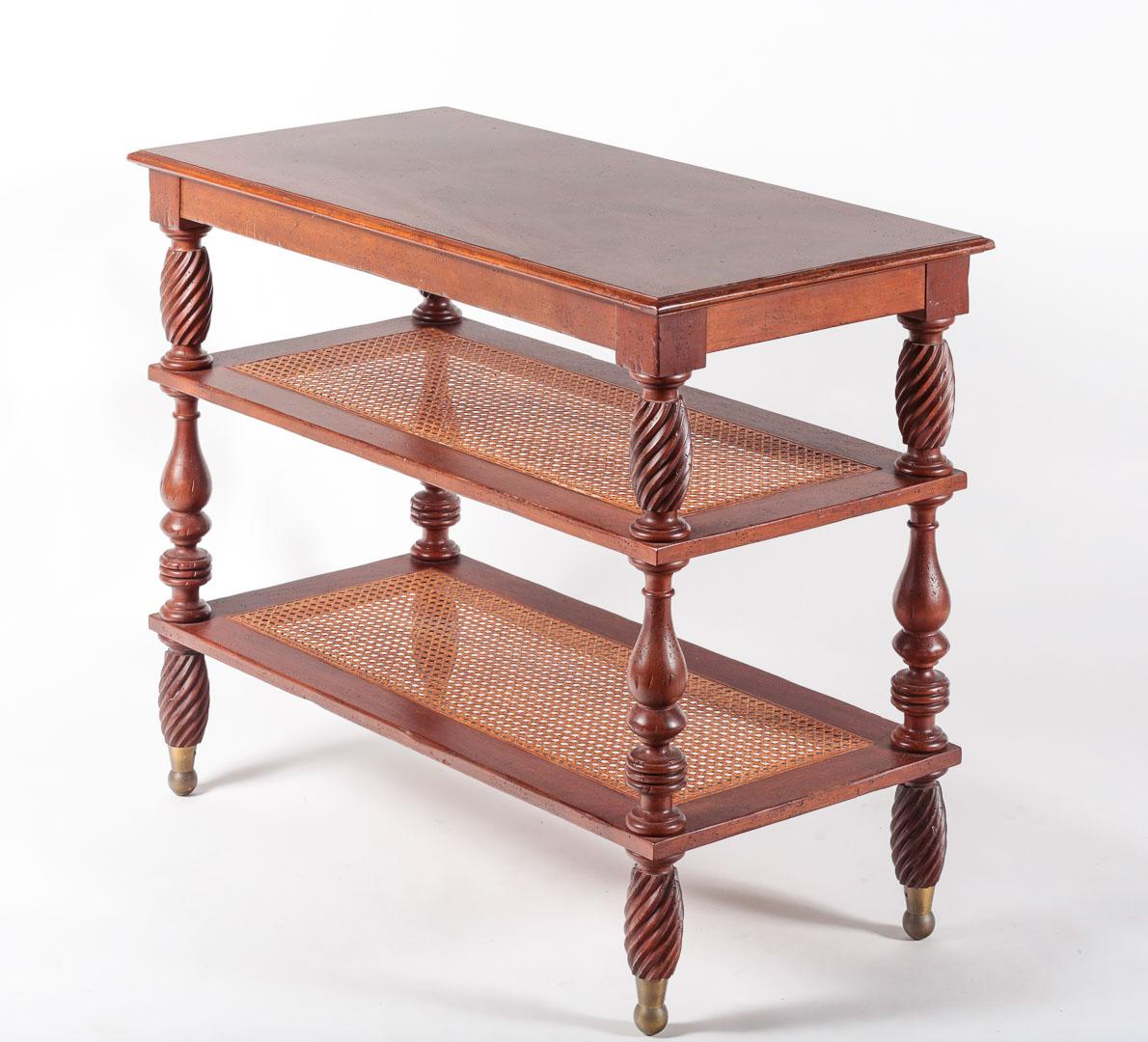 Vintage British Colonial style mahogany étagère/ occasional table with solid top and two woven cane shelves and brass ferrules, marked Baker Furniture.