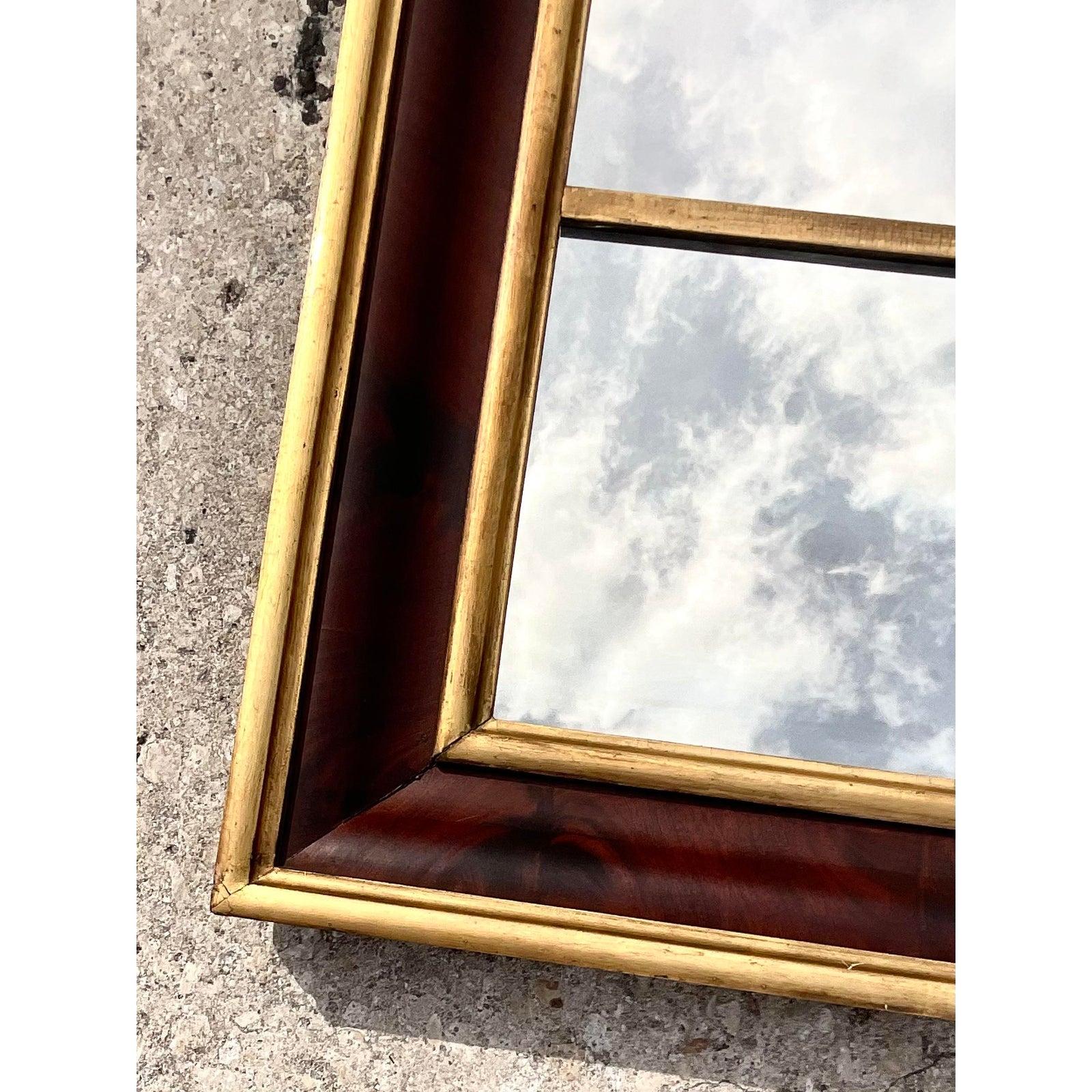 Stunning vintage Mahogany flame wall mirror. Beautiful Burl wood detail with chic gilt touches. This mirror has some serious age to it, but in great shape. A classic addition to any décor.