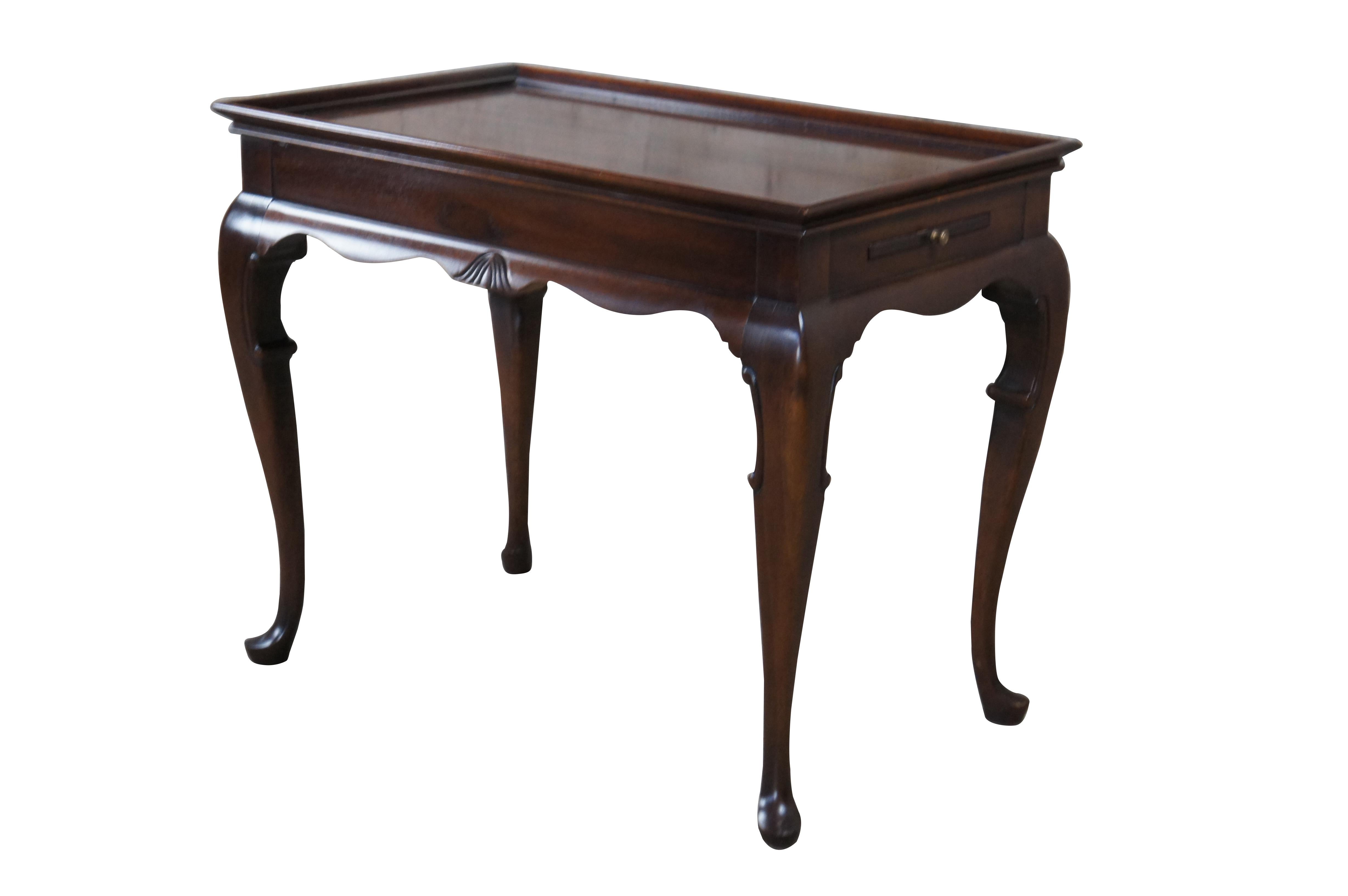 Vintage Georgian / Queen Anne style accent table.  Made of mahogany featuring gallery top with two pull out trays, serpentine accents, cabriole legs and slipper feet.

Dimensions:
30.5