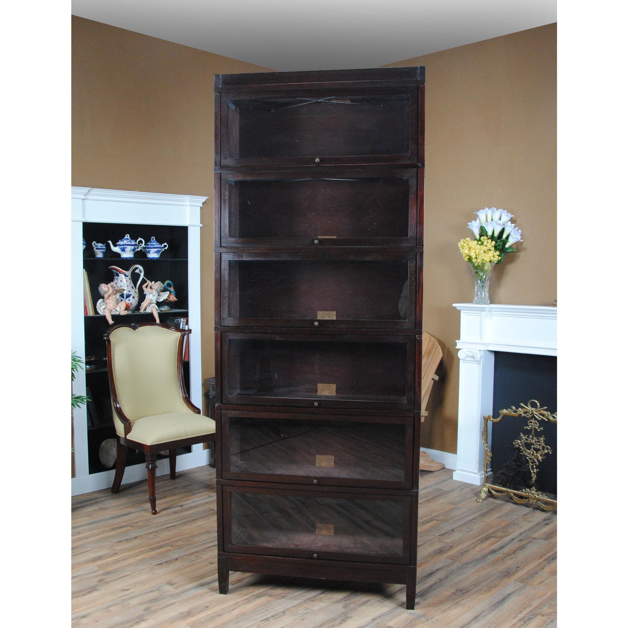 A Vintage Mahogany Globe Wernicke Bookcase – the perfect addition to any home or office space! Crafted from high-quality mahogany wood, this bookcase is about 100 years old but still exudes the same elegance and sophistication as when it was first