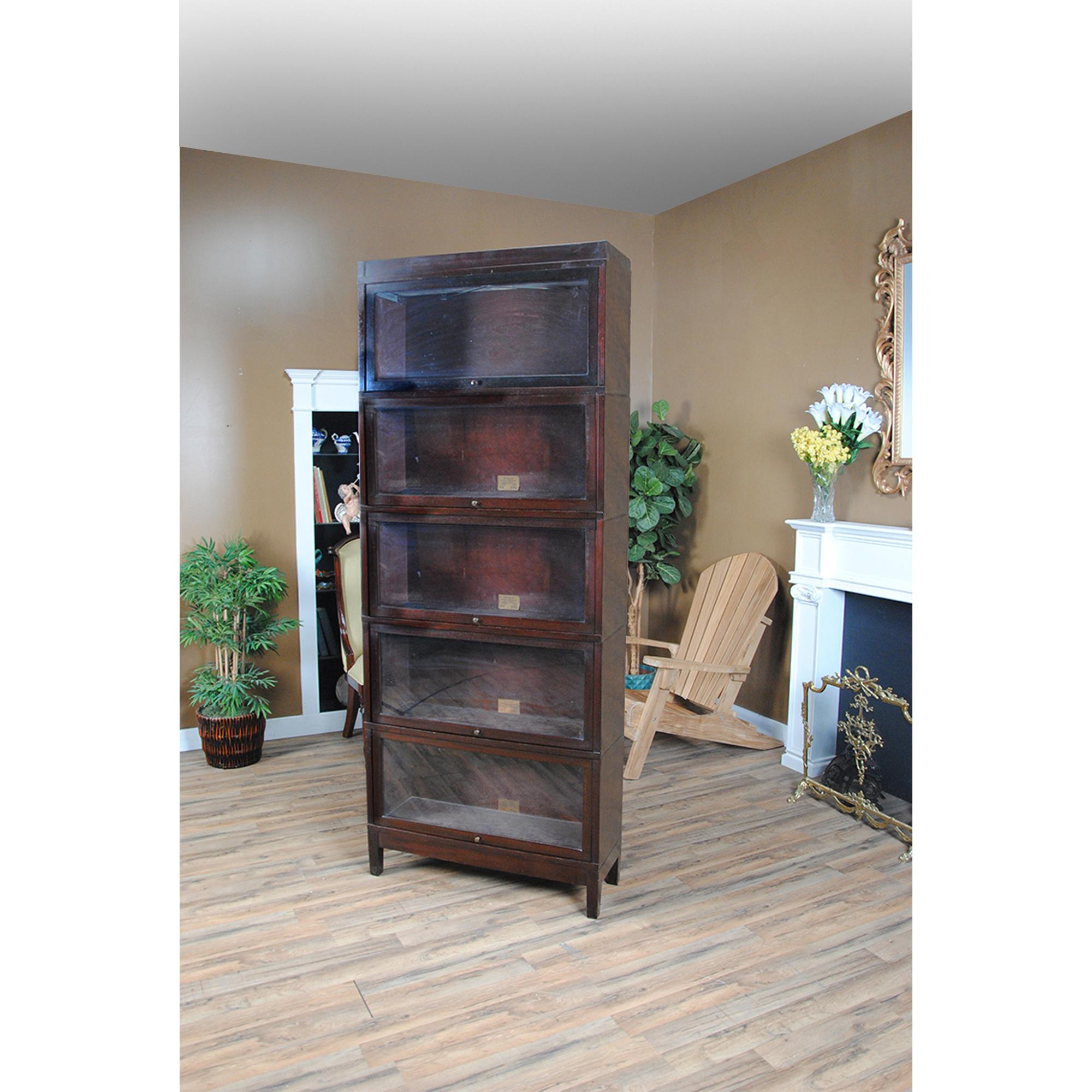 A Vintage Mahogany Globe Wernicke Bookcase – the perfect addition to any home or office space! Crafted from high-quality mahogany wood, this bookcase is about 100 years old but still exudes the same elegance and sophistication as when it was first