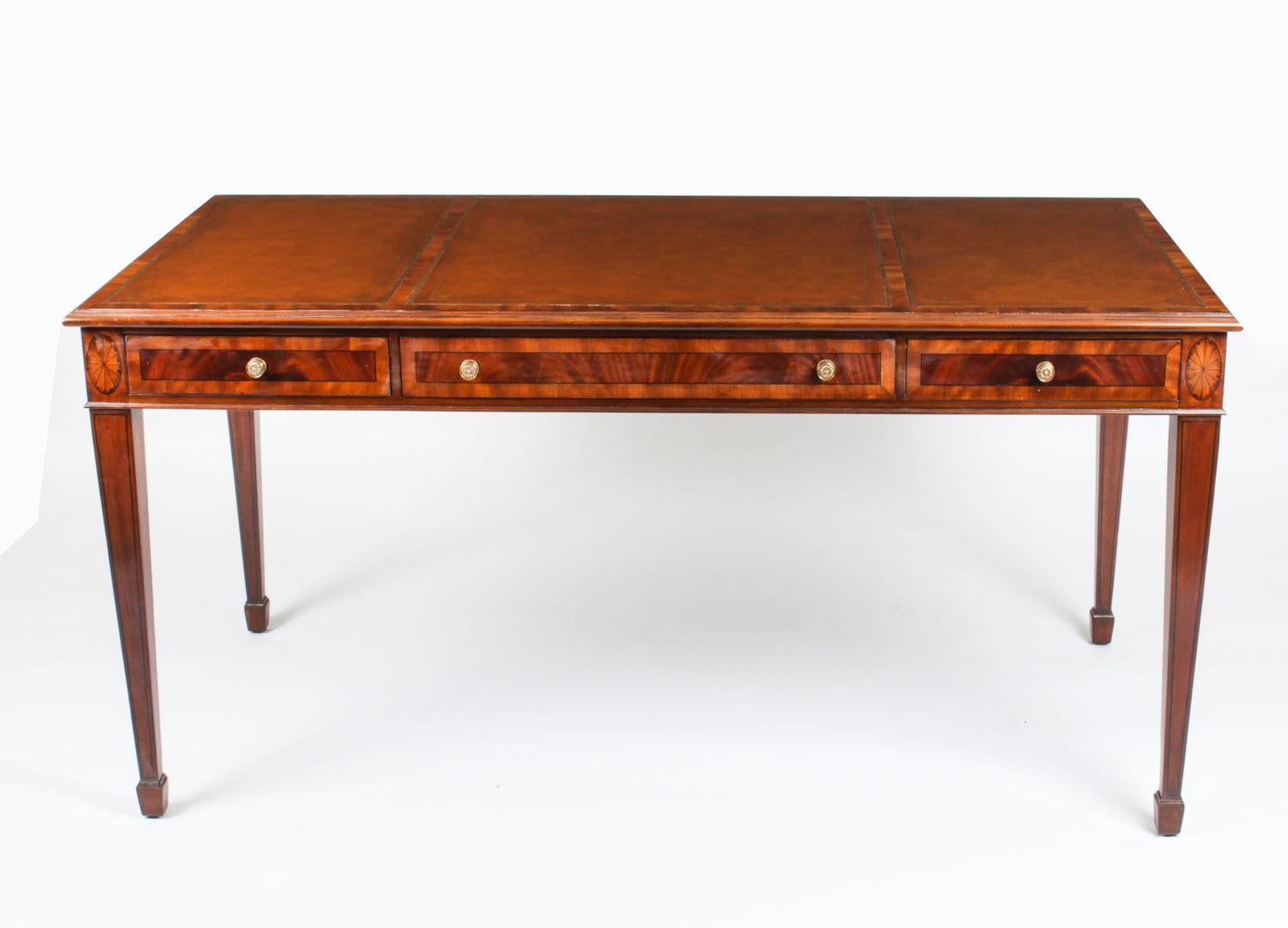 A beautiful elegant vintage partners writing table in the Victorian manner, and dating from the late 20th Century.

This gorgeous desk is crafted from beautiful flame mahogany with satinwood crossbanding and shell inlay and features a striking