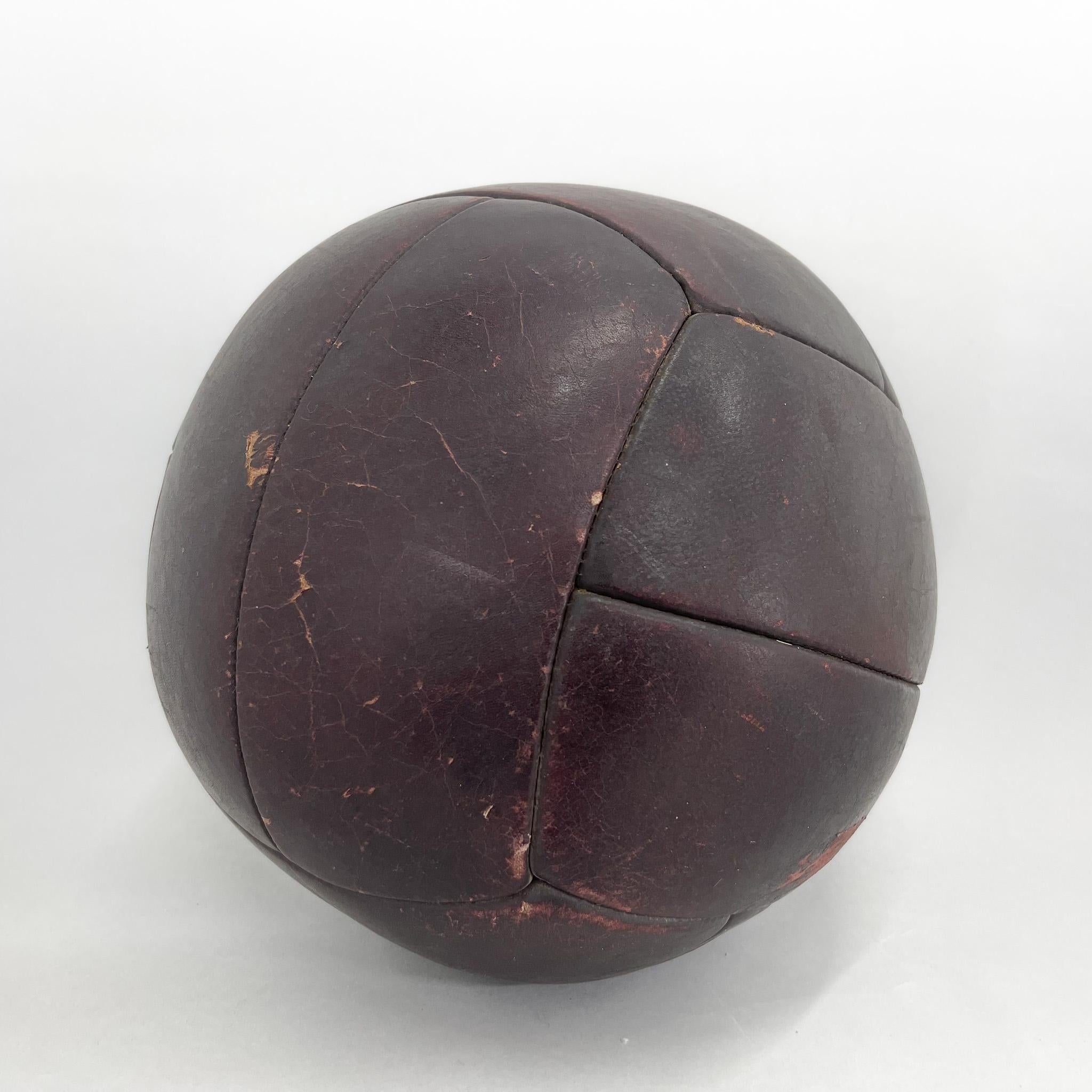 Original vintage heavy leather training ball with beautiful patina. The ball is made of handstitched genuine leather in former Czechoslovakia in the 1930s. It can be used as an original interior accessory or as a stylish training aid. The leather