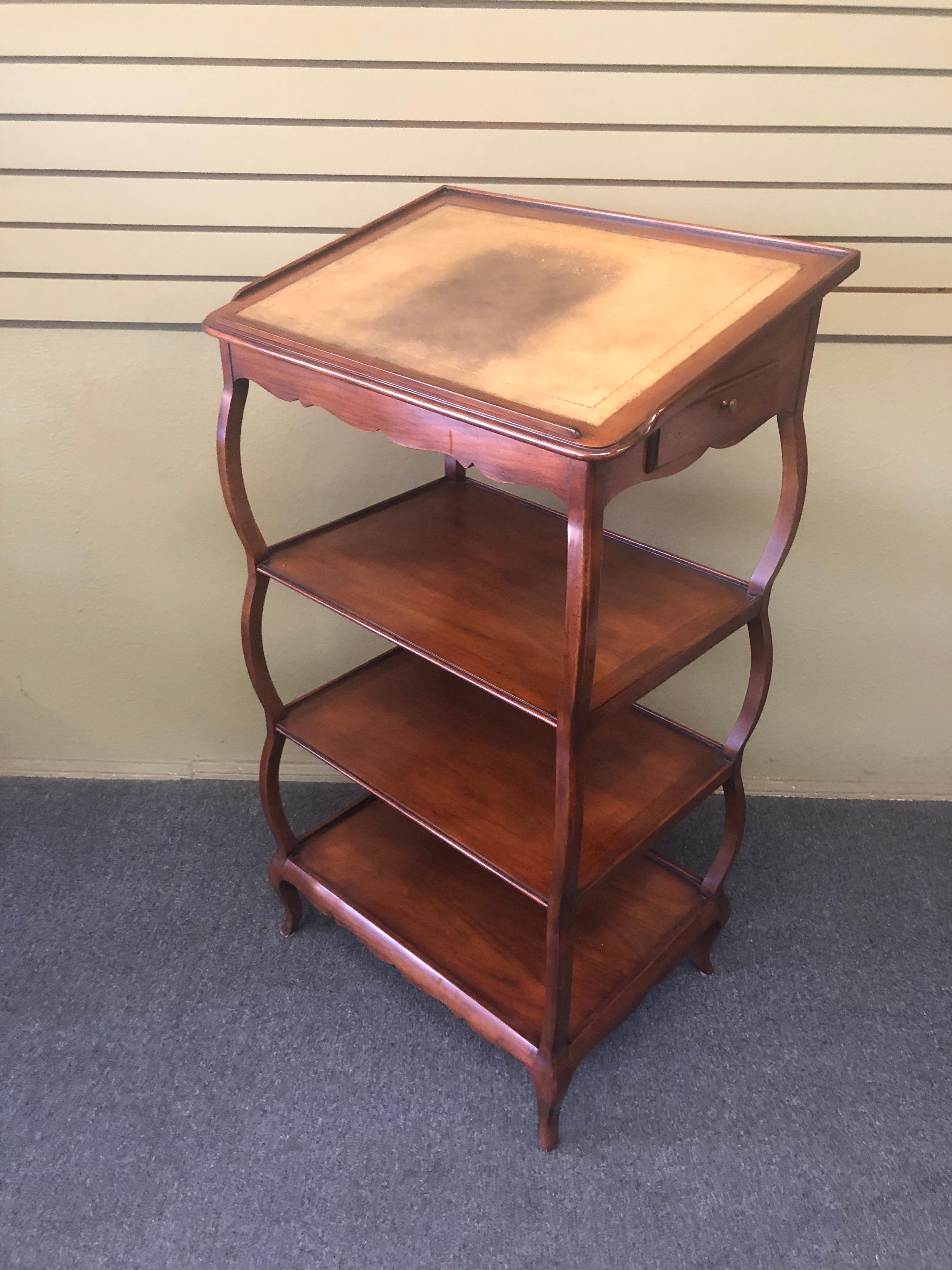 Vintage mahogany lecturn with side drawer and three shelves by Baker Furniture Company, circa 1980s. Avery attractive and functional piece! #1271.