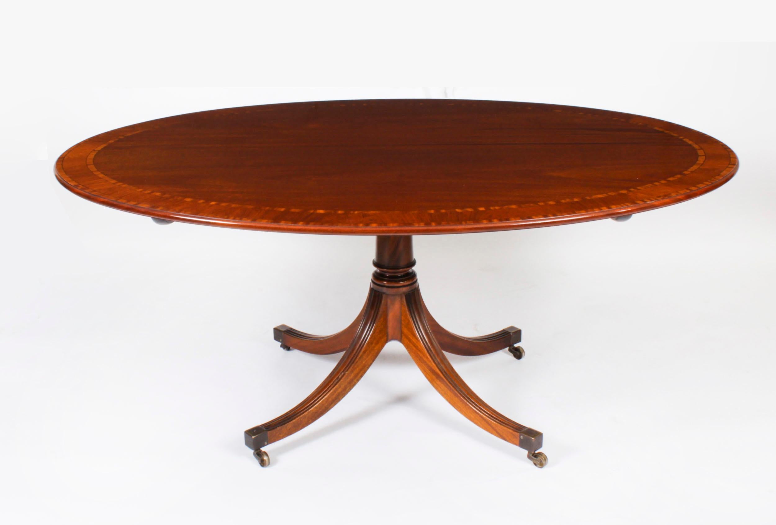 This is a beautiful Regency Revival flame mahogany and satinwood banded oval dining table  dating from Circa 1980 made by the Master Cabinet maker William Tillman and bearing his label on the underside.

The fabulous 5ft 6inch flame mahogany tilt