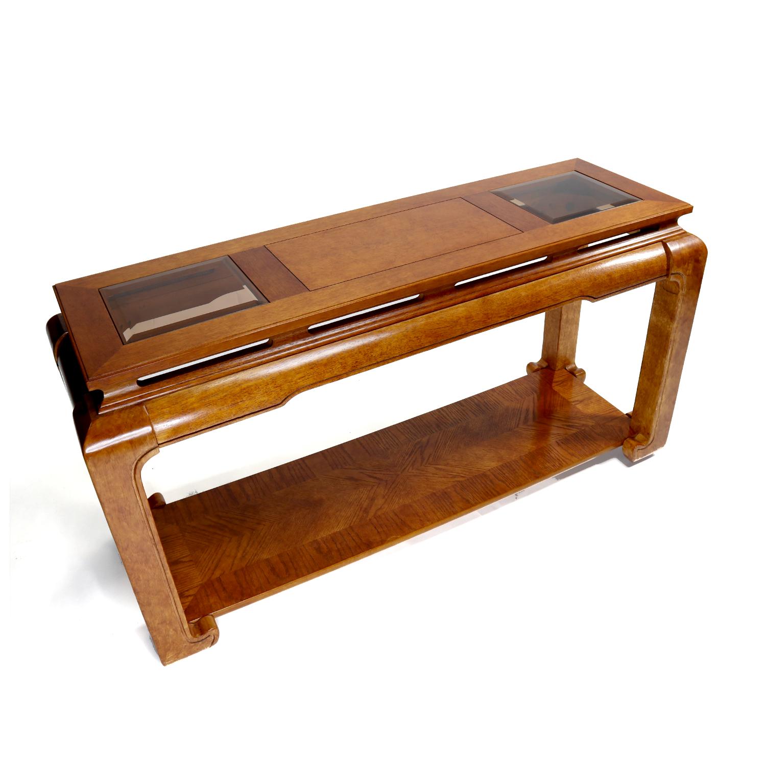 Vintage solid wood Chinese sofa table with elegant beveled glass inlay. This sofa table is unusual for it’s solid wood (most likely mahogany) construction and petite stature. Most post-war furniture is a mix of solids and veneers. This piece is